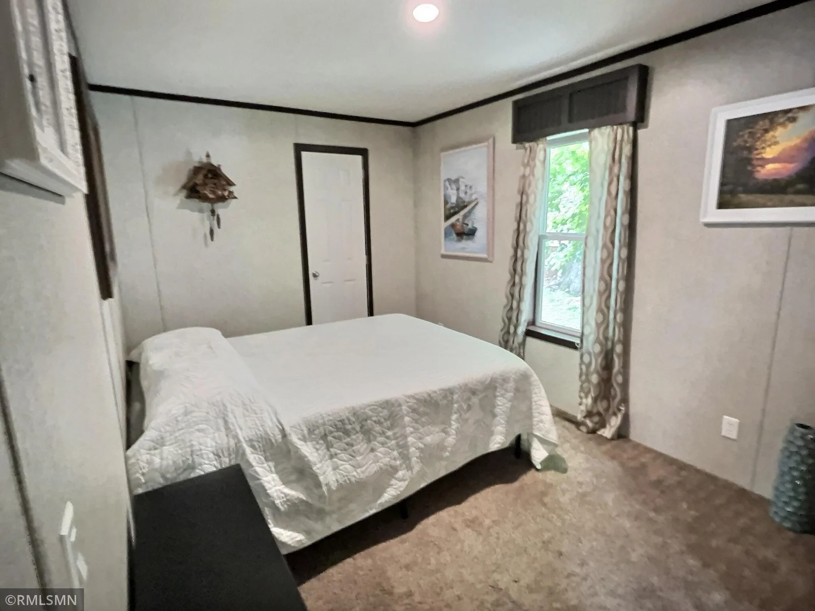 The 2nd bedroom offers nice carpeting and window to watch wildlife.
