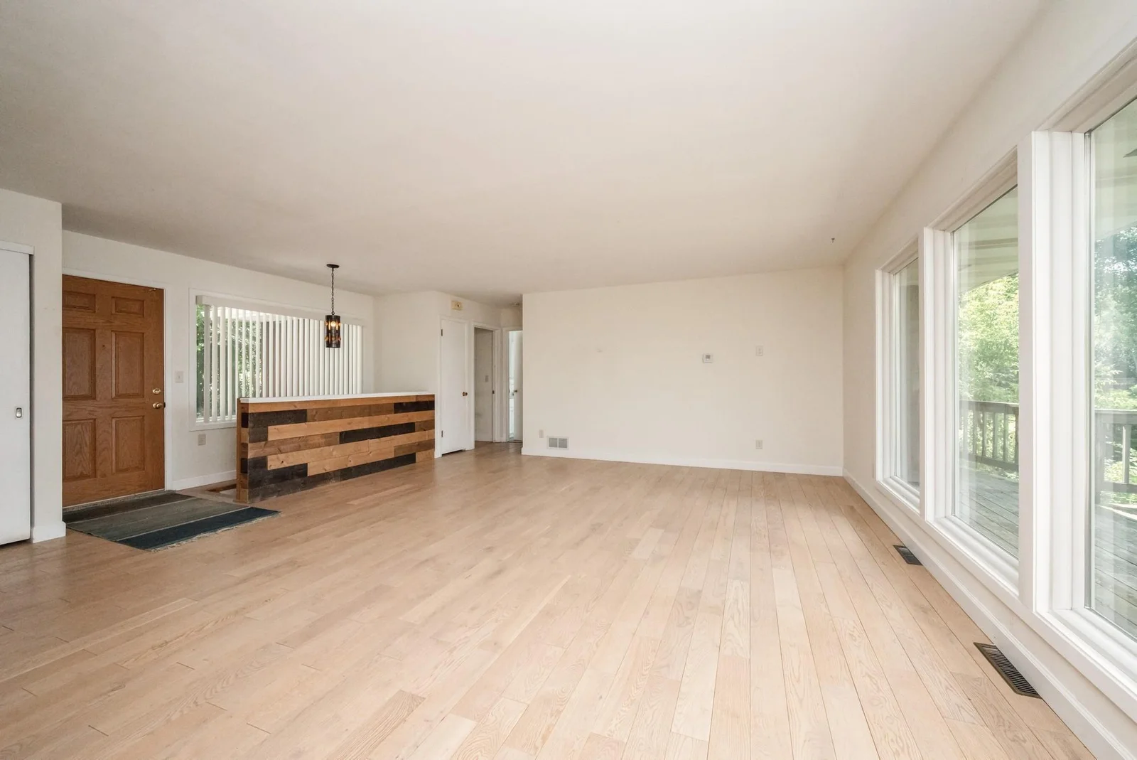 Spacious living room with a large window offering a beautiful view of the lake