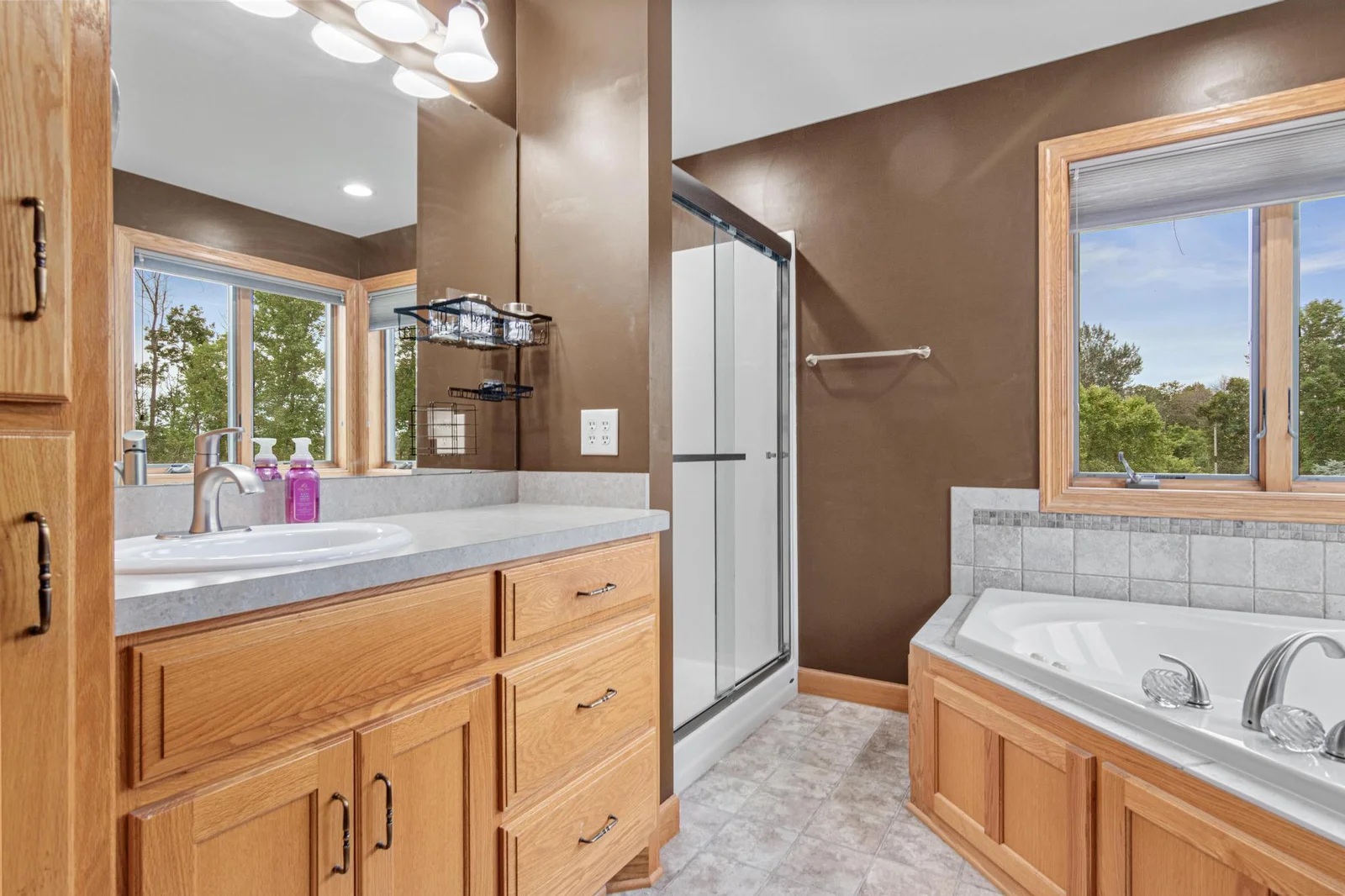 The private, primary bathroom has a separate tub and shower. The shower doors are soft-closing! The window blinds are top-down-bottom-up design. There is also a linen closet in this room.