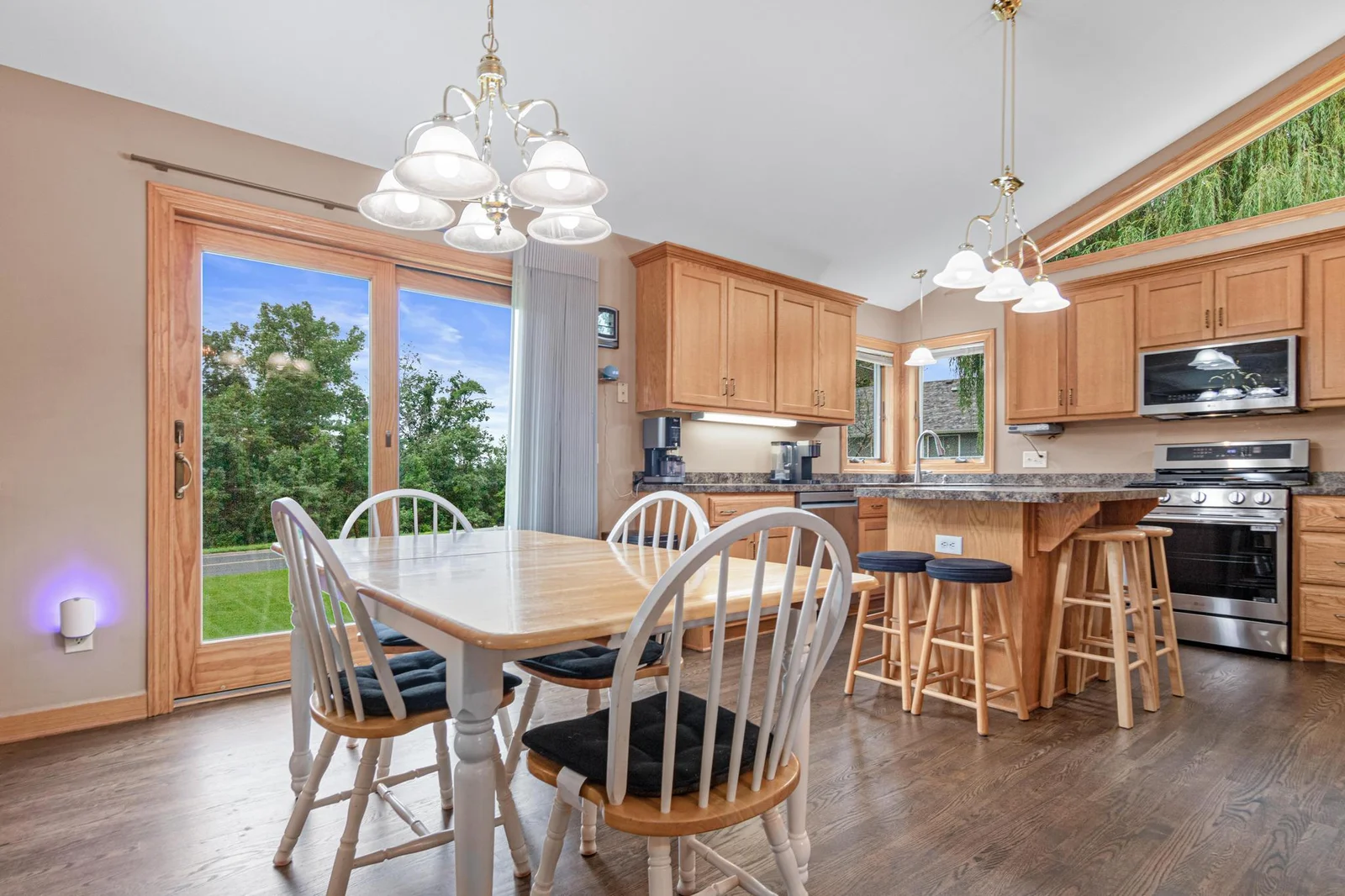 The sunny kitchen has vaulted ceilings and new appliances. There are two dining areas in the home; the kitchen has space for a large table and there is a separate formal dining room.