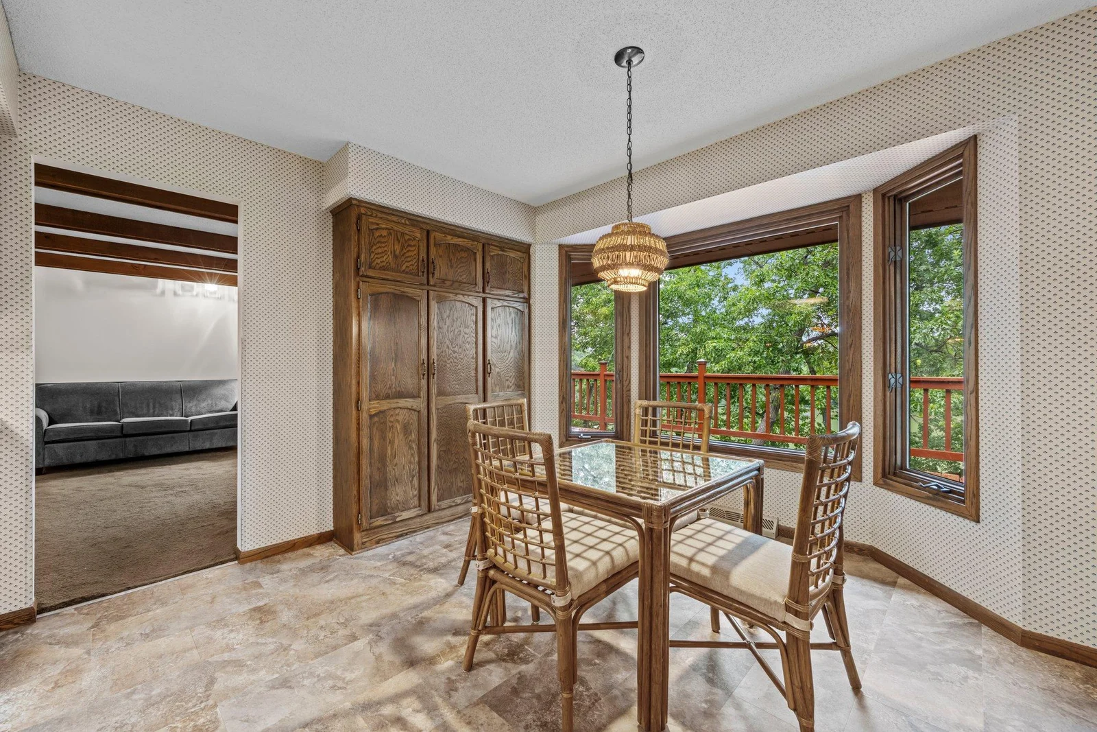 The informal dining room has a wonderful pantry and is a wonderful space to enjoy a coffee with views of Karth Lake.
