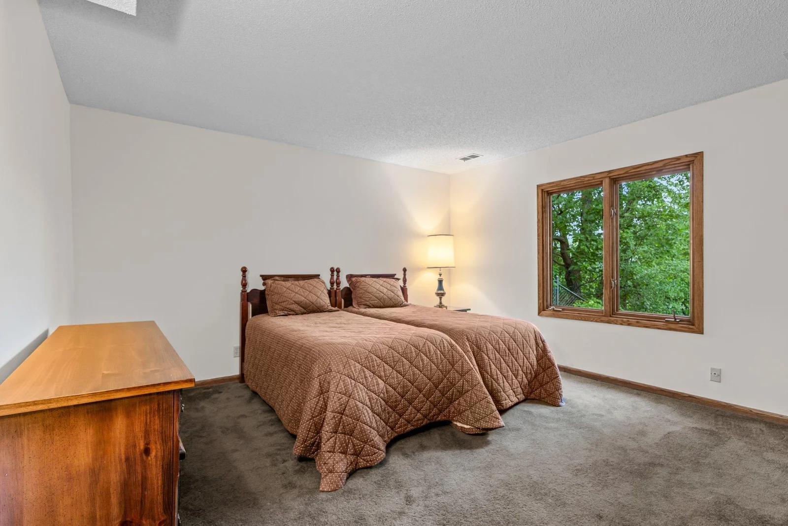The lower level bedroom is very spacious and looks out toward Karth Lake.
