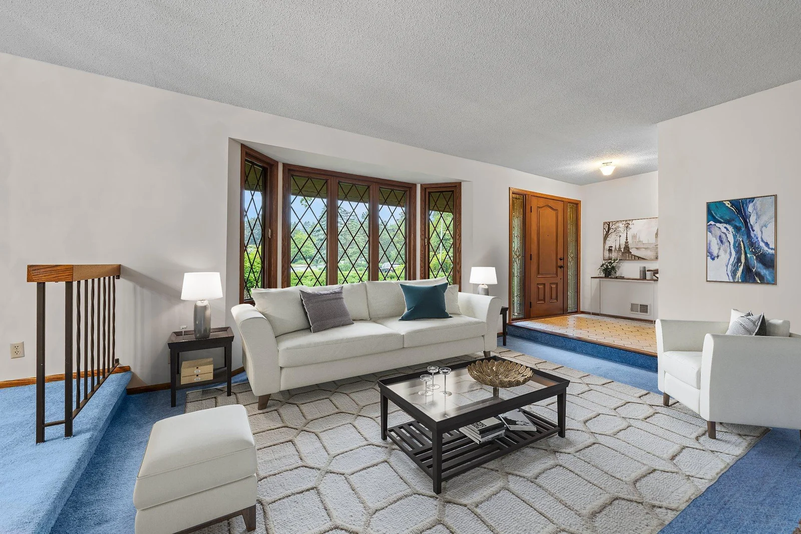 The formal living room off of the foyer. The bay window adds natural light stream into the room. This room has been virtually staged.
