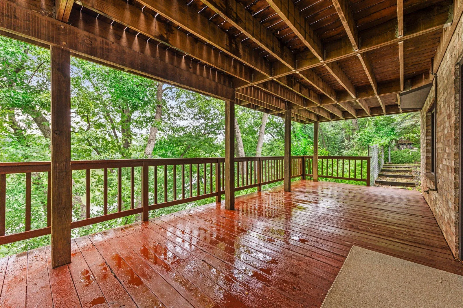 The lower level deck glistening after a summer rain shower. Such a great place to gather or just to relax by yourself.