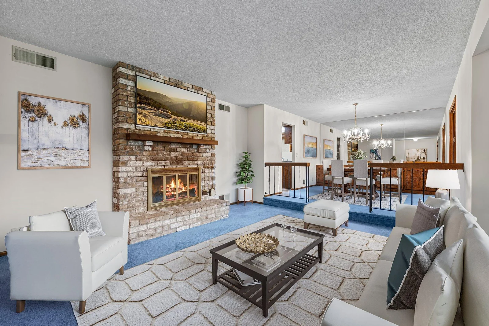The living room and dining room located immediately off of the foyer. There is a brick fireplace to keep you warm.  This image is virtually staged.