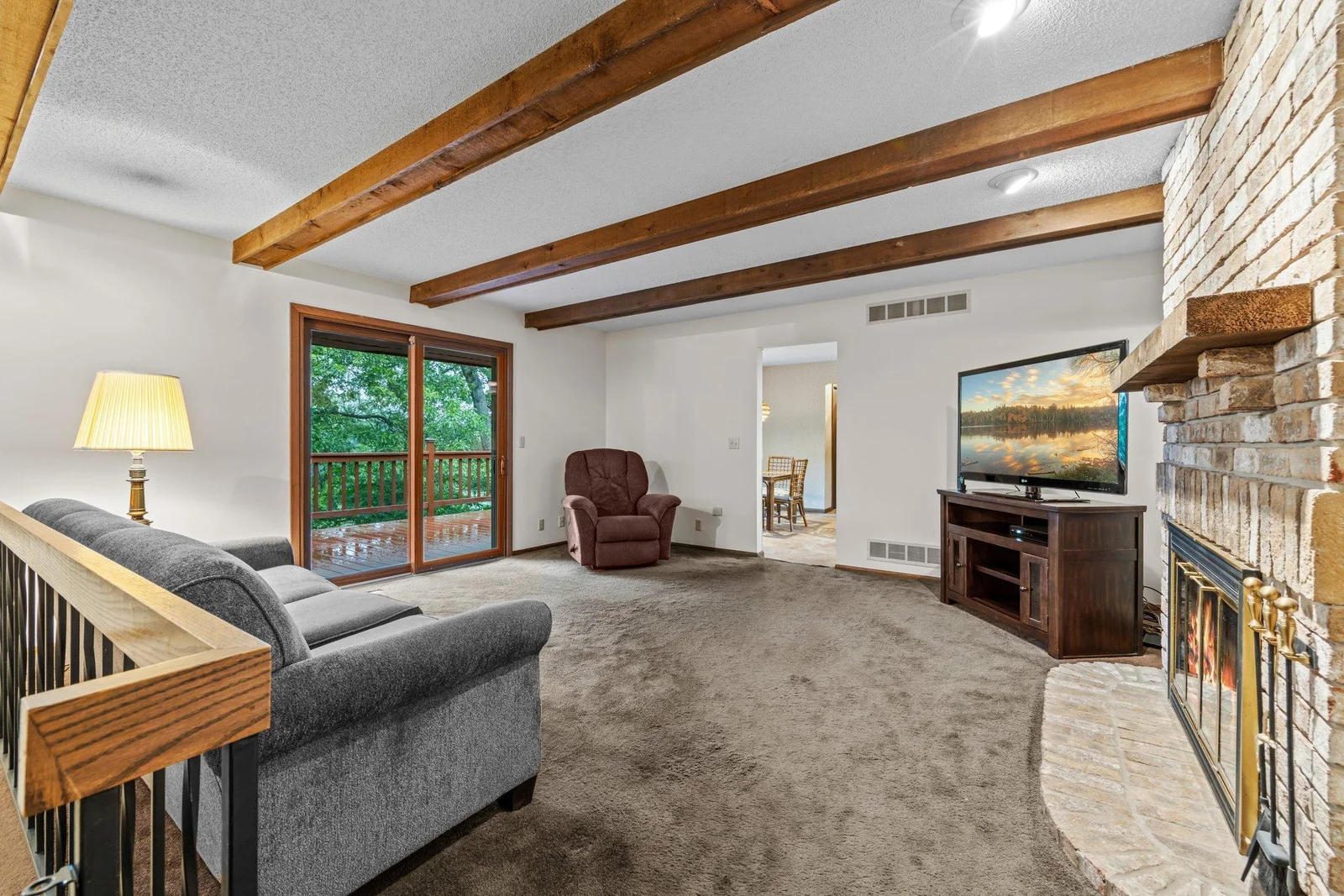 View of the living room looking toward the deck which faces Karth Lake.