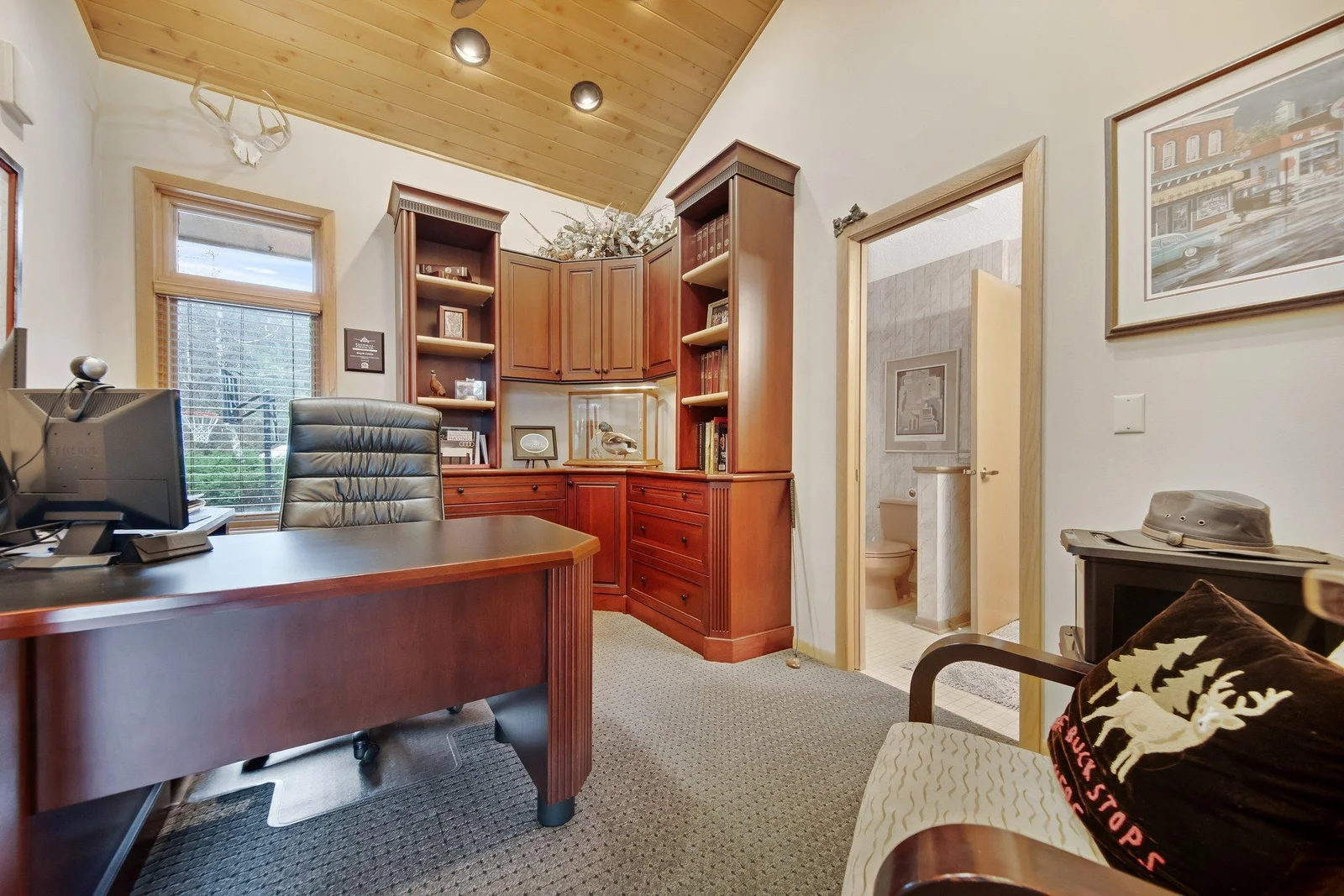 Main floor study - could also be converted into a nursery or main floor bedroom - pocket door leads to a full bath and another door on the other side of the bathroom.  Cherry built in shelving with large Cherry desk.