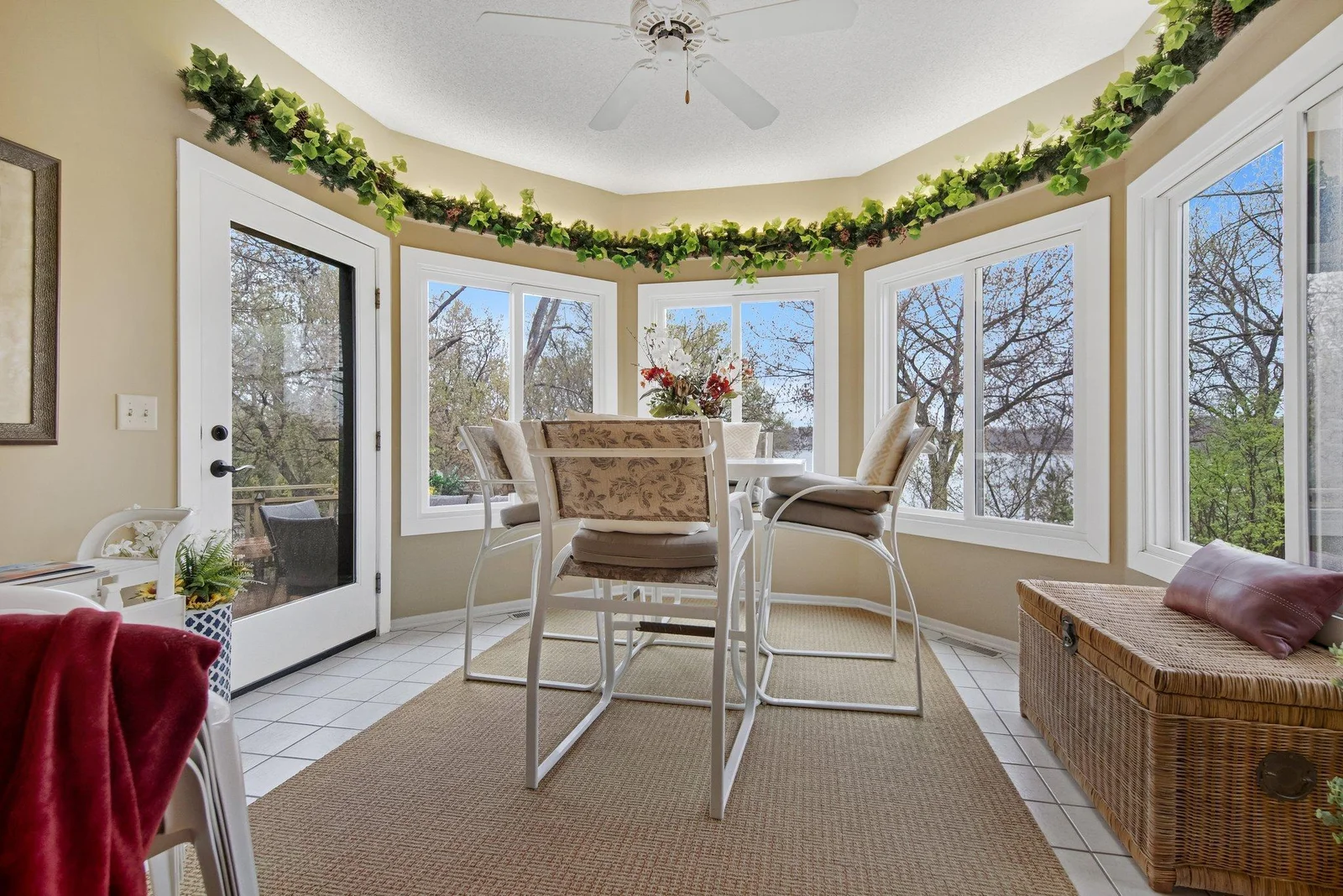 The porch has a multitude of windows and an entrance out onto the large deck - the home was custom designed and has been meticulously maintained.