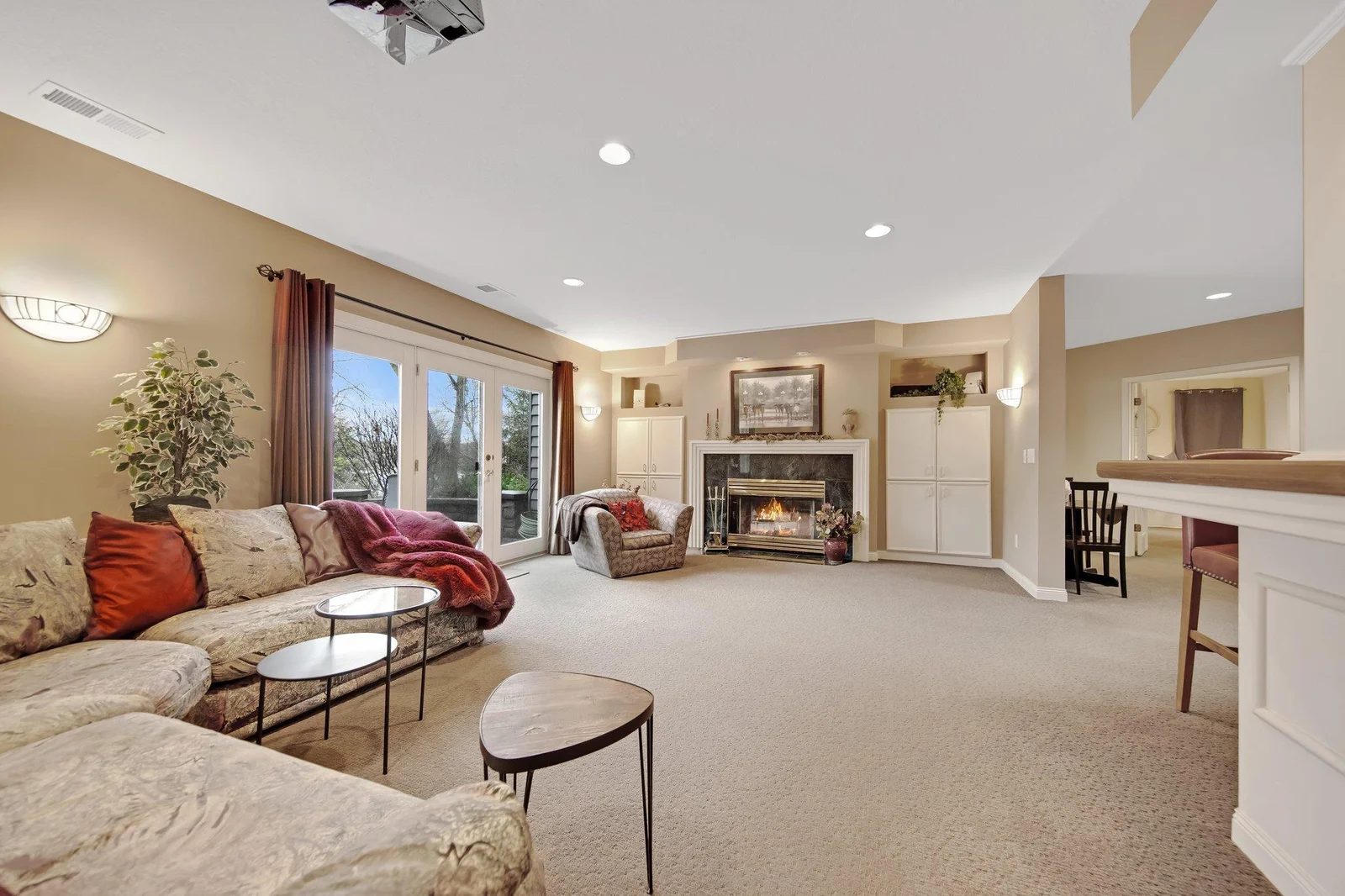 Lower level wood fireplace and surround sound stereo system in the cabinet to right of fireplace
