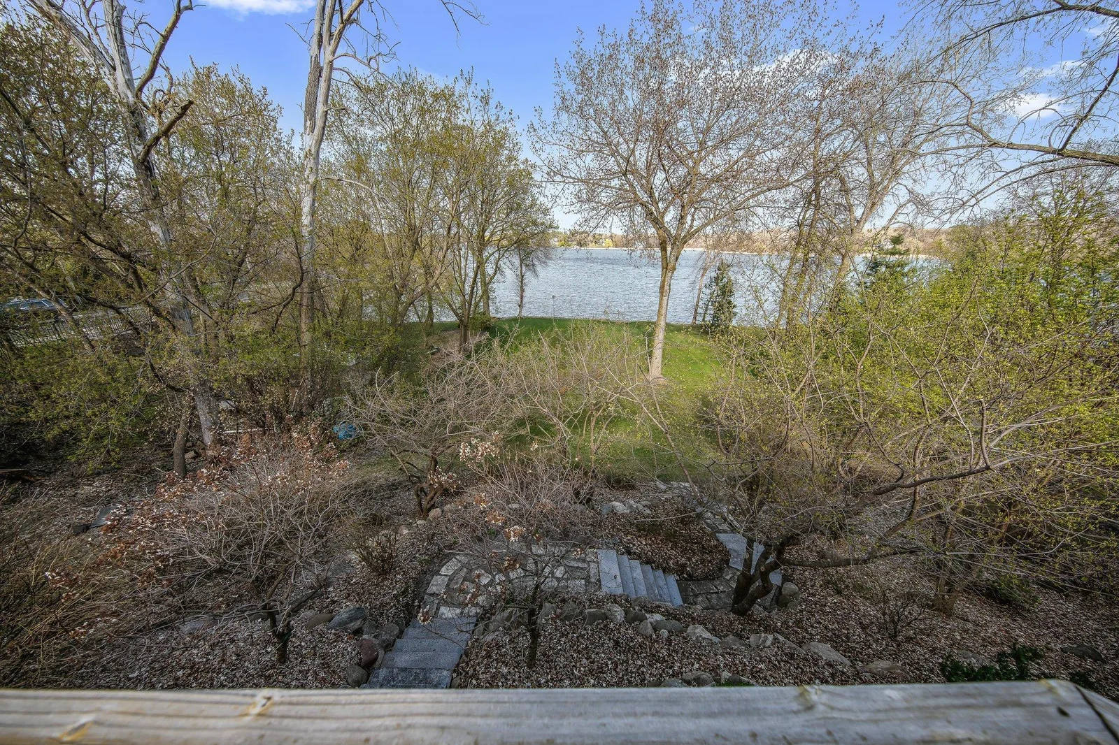 Firepit in trees tucked away for campfires and entertaining.  There is also a utility shed below to store water toys, outdoor furniture and lawnmower.  - Seller is willing to sell the lawnmower as well.