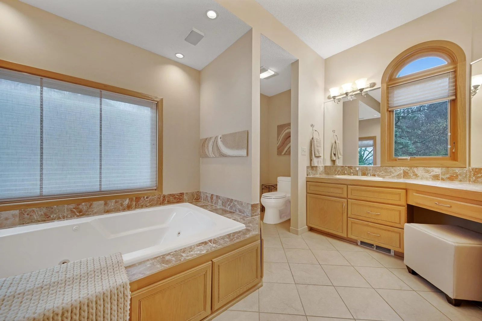 Large primary bathroom with heated tile flooring and double sinks - great soaker tub.