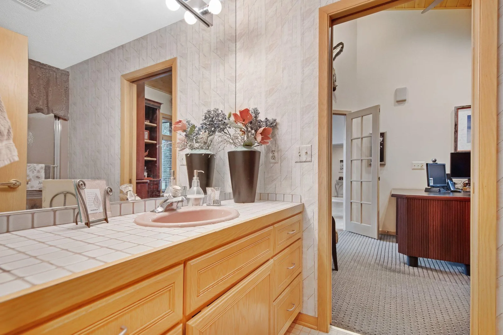 A view from the powder room (full bath) into the main floor study - study has glass double doors to provide for privacy - a great space for working from home.