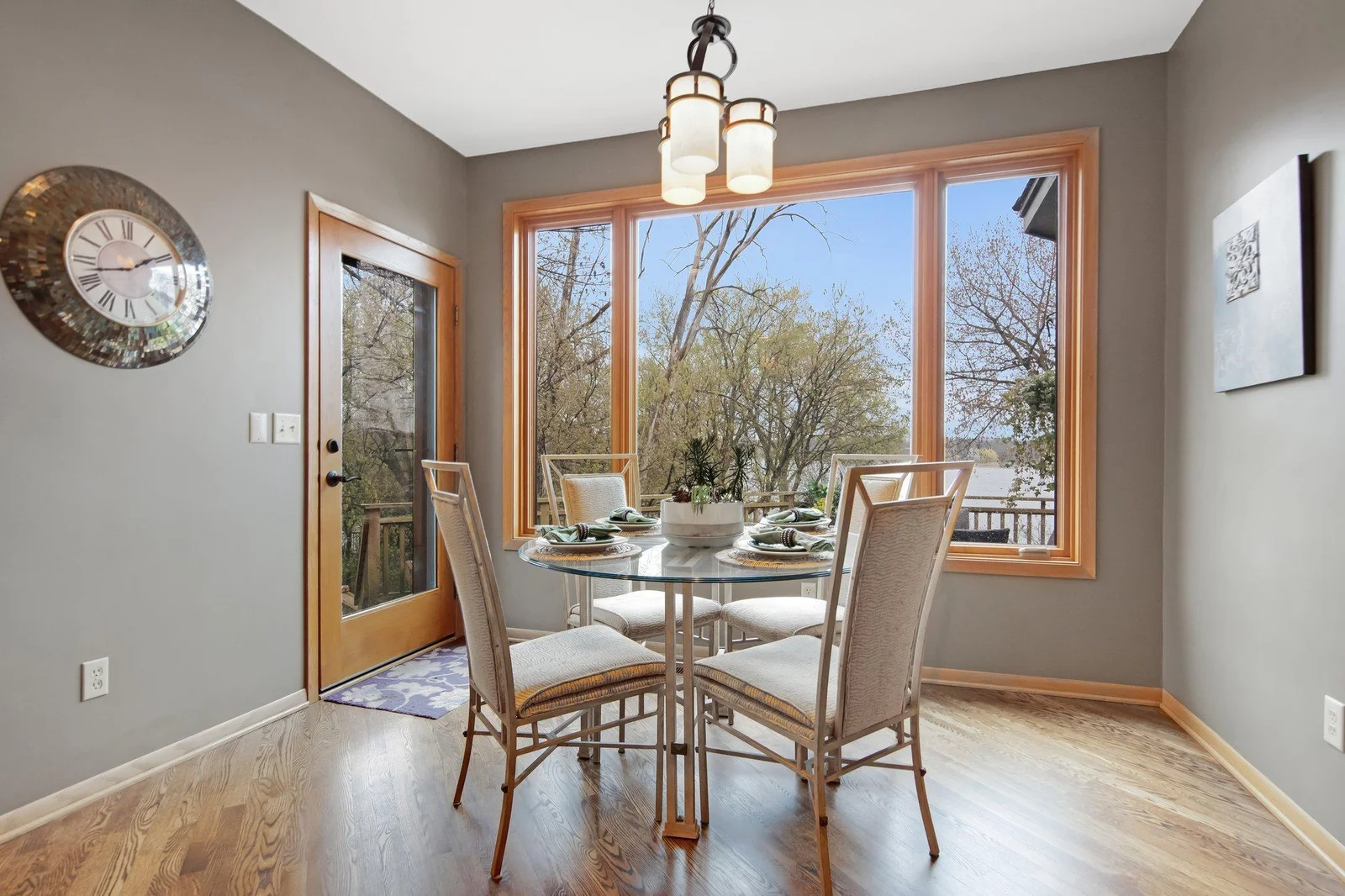 formal dining area with large window overlooking the lake and another entrance out onto the large deck