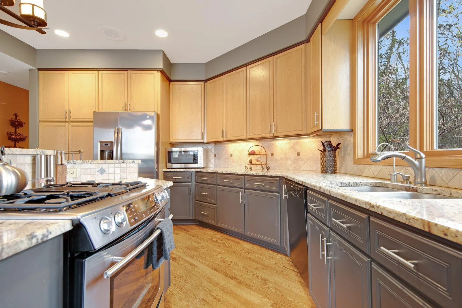 Stainless steel appliances and a large kitchen window