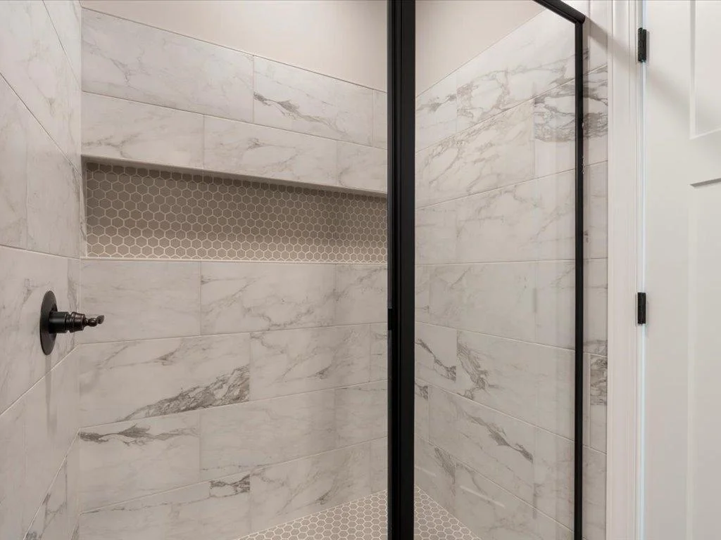 Tile shower with large niche looks amazing.