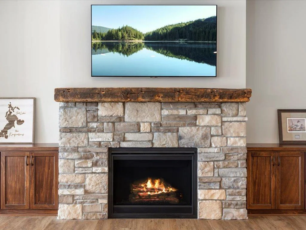 Stone fireplace and authentic barn wood mantle complete with built-ins on each side.