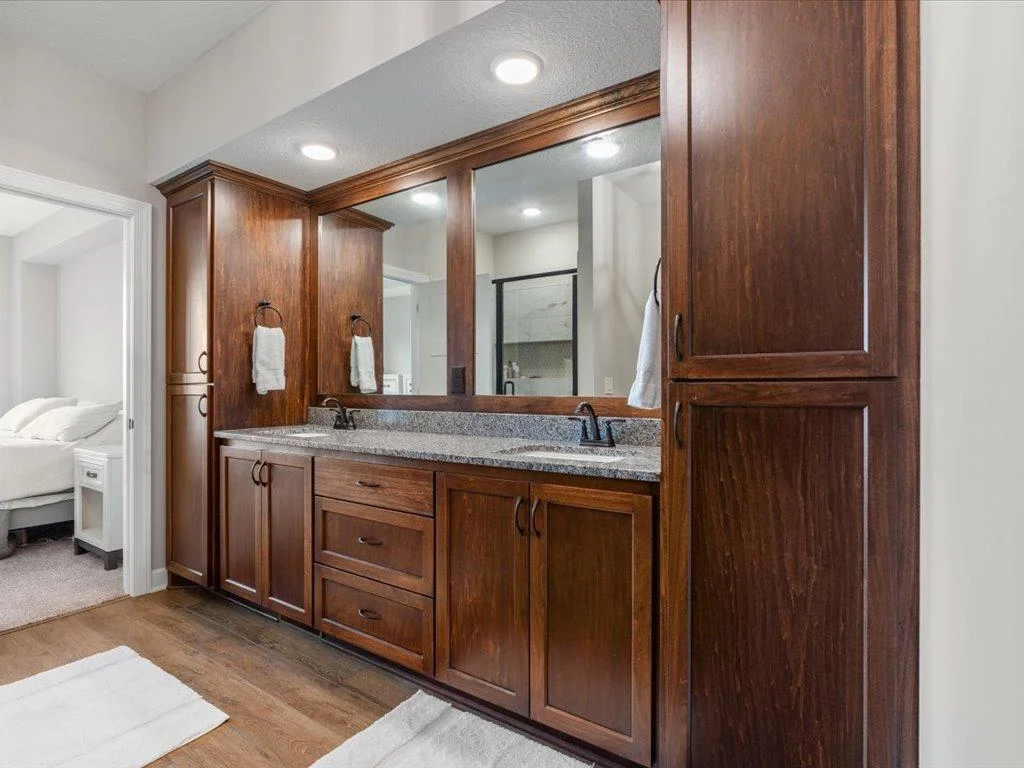 His and her sinks with granite tops and two linen's in master bath.