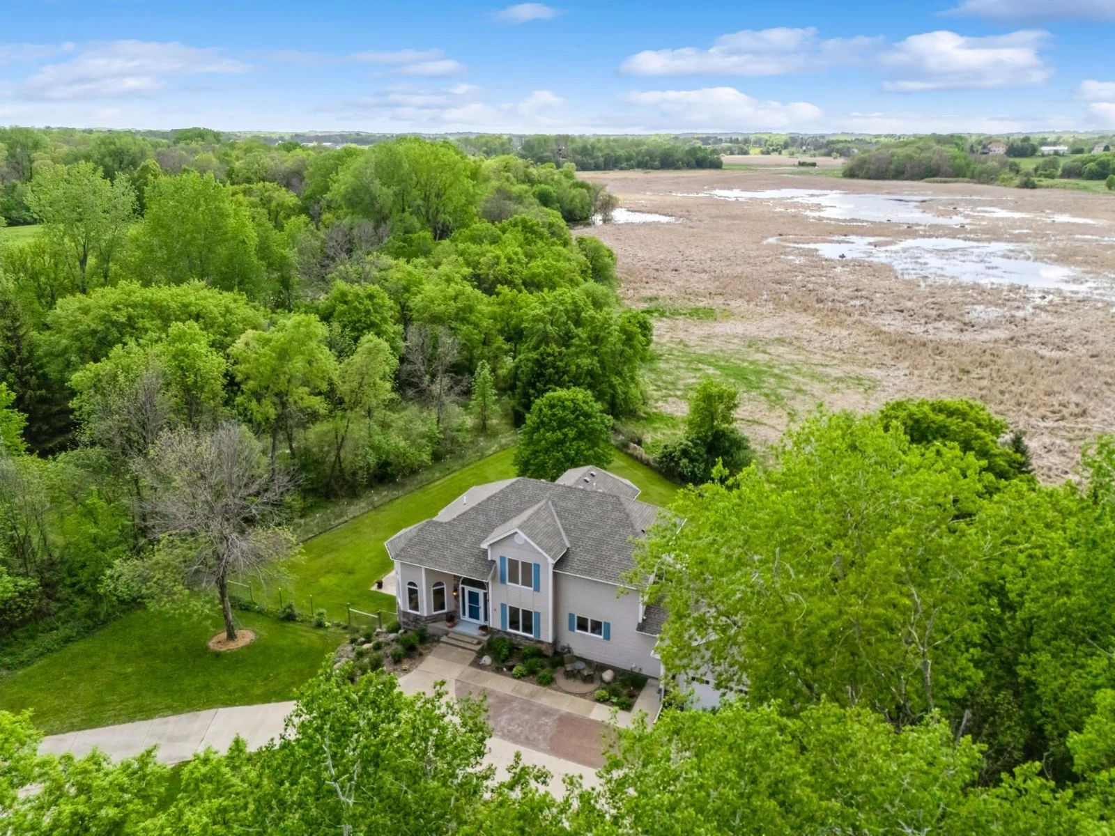 Peaceful setting on 6.5 acres with sweeping views of wildlife filled wetlands and wooded privacy.