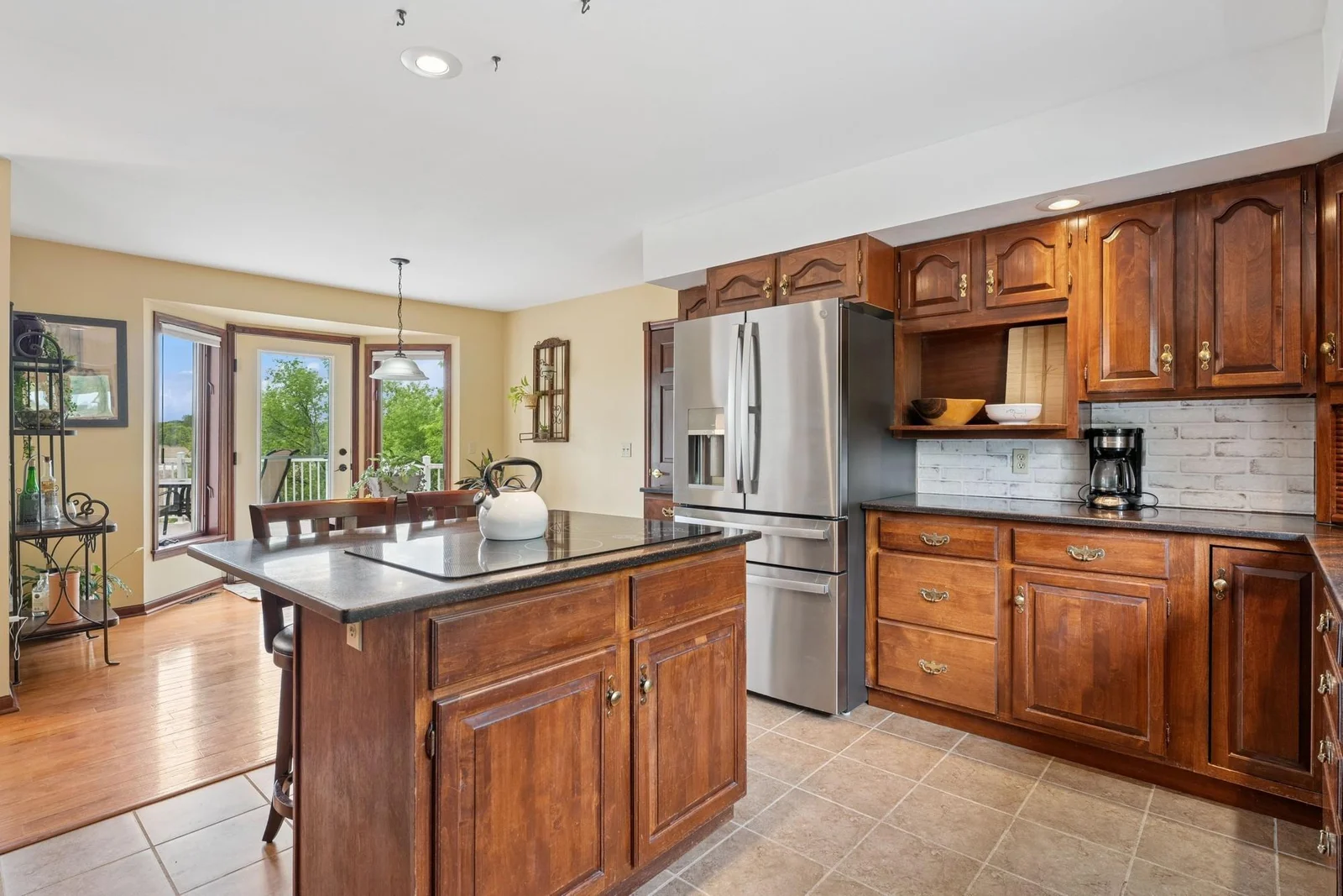 Plenty of cabinet and counter space in this well appointed kitchen with eat-in dining and center island.