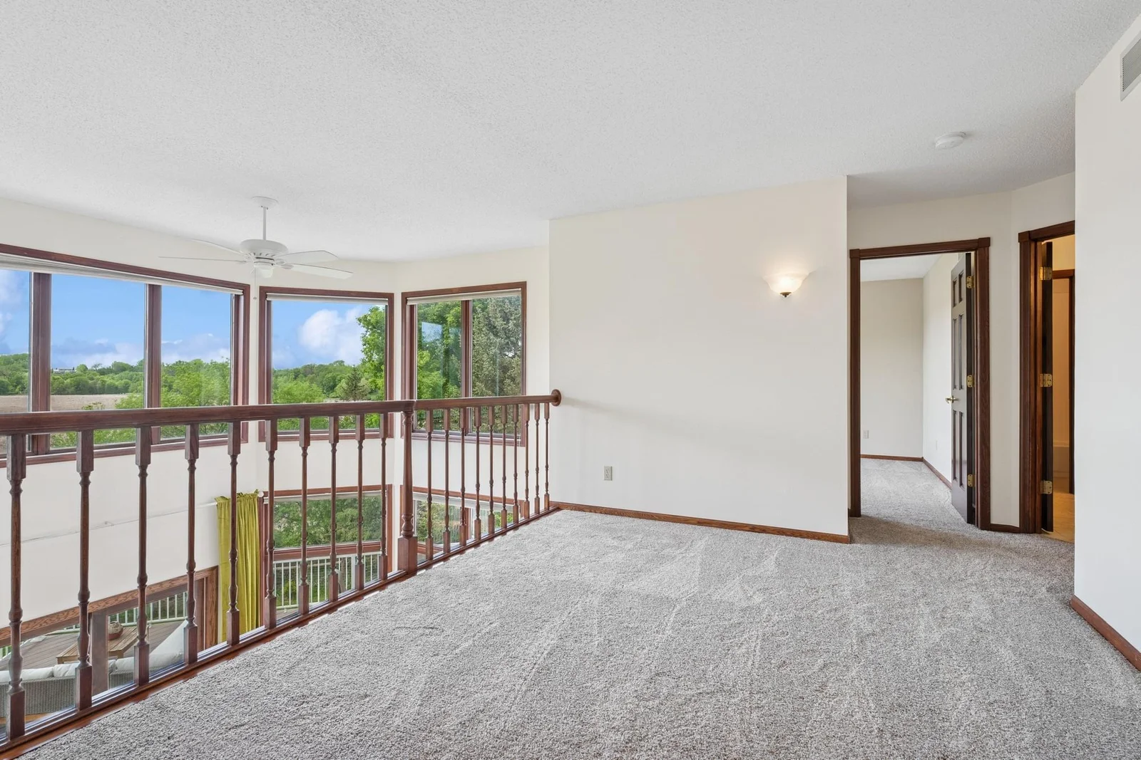 Loft overlooking living room with gorgeous views through stunning wall of windows
