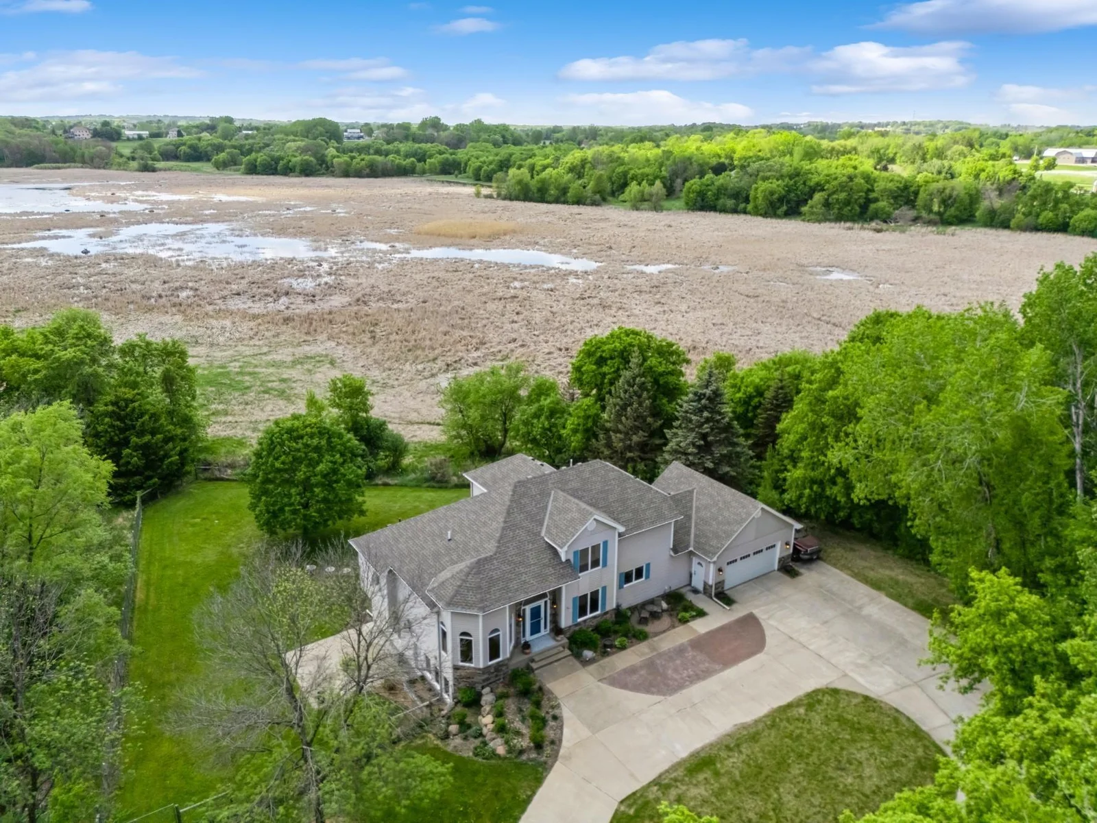 A concrete circular drive leads you to this beautiful 2-story.