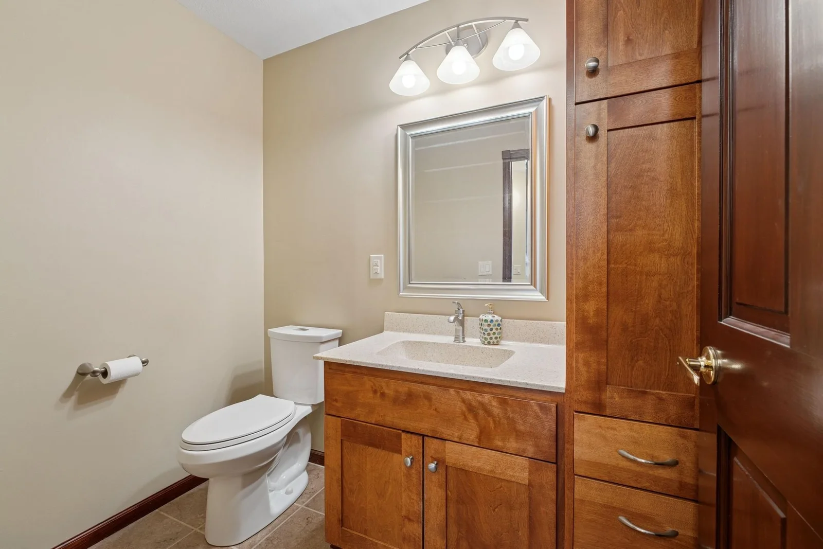 Main level half bath with beautiful cabinetry