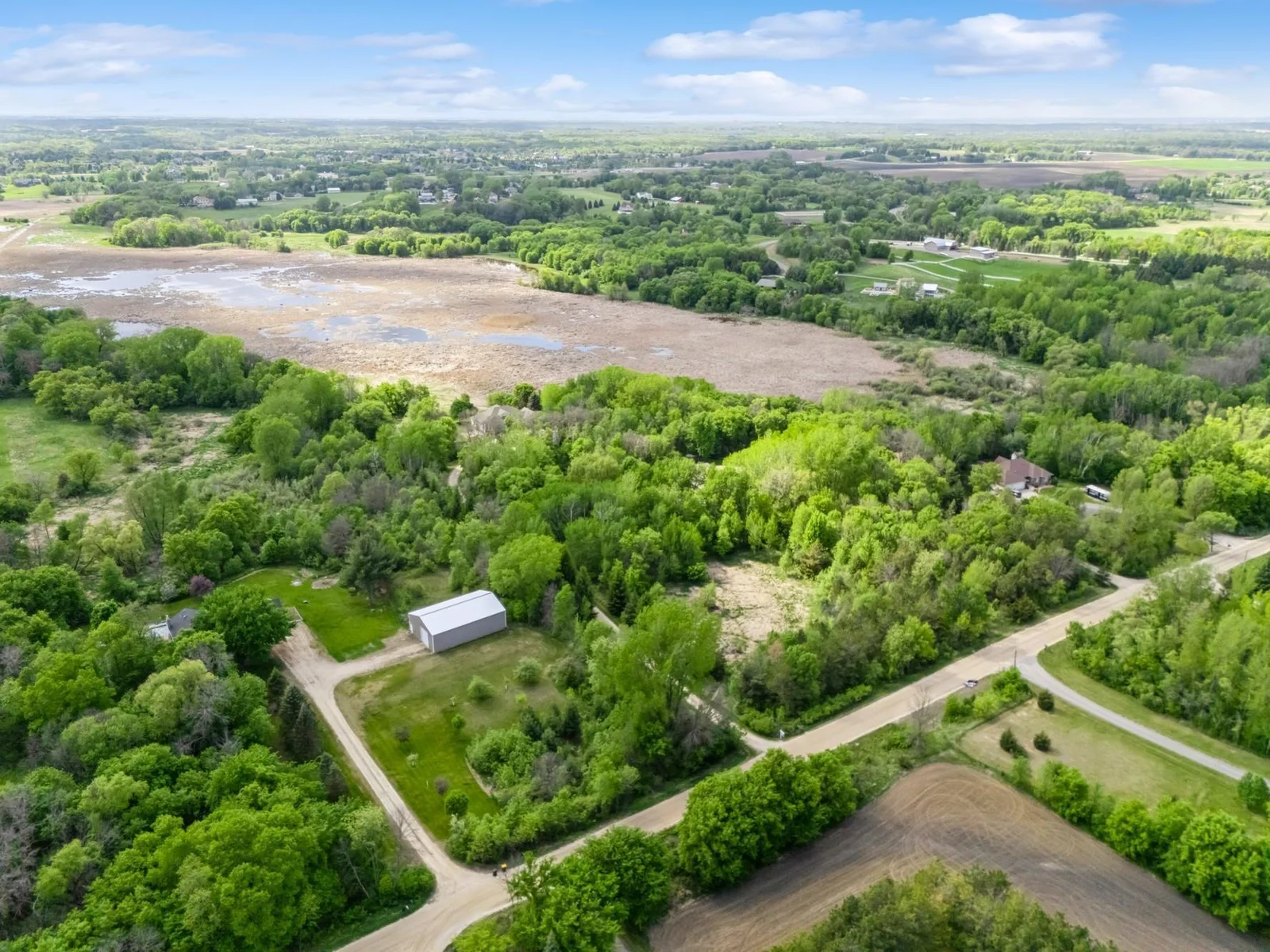 Peaceful setting on 6.5 acres with sweeping views of wildlife filled wetlands and wooded privacy. Accessed by scenic wooded drive that opens to a concrete circular drive.