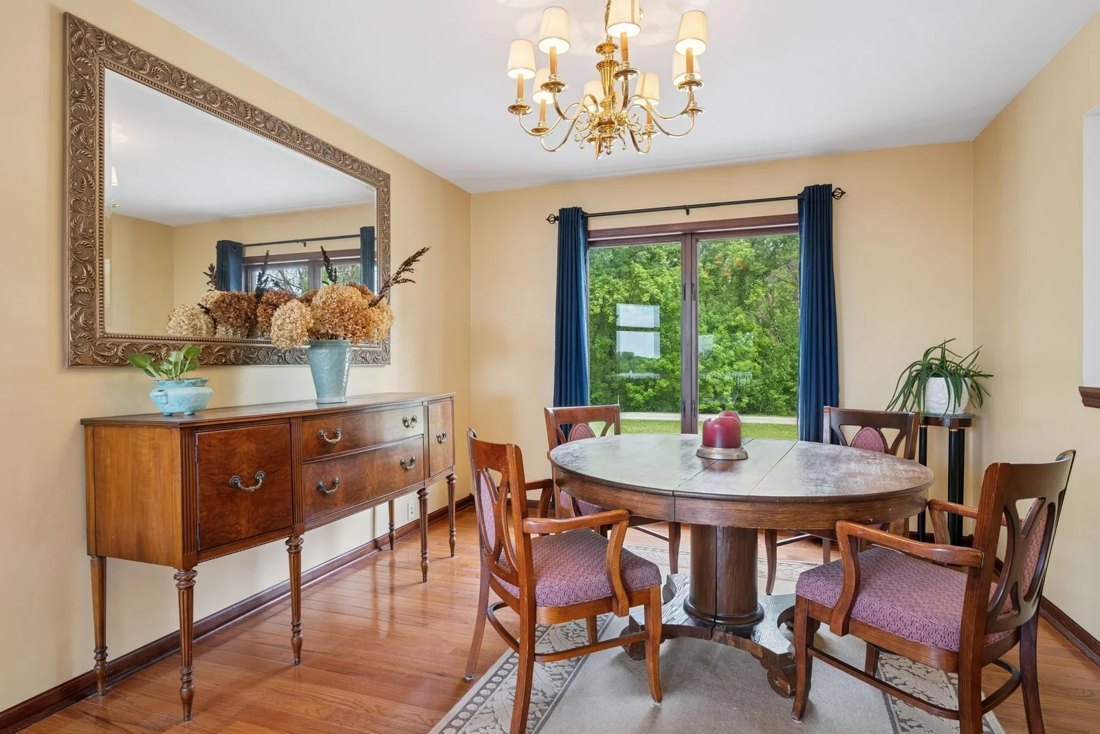 Formal dining with bay window overlooking front yards and woods.
