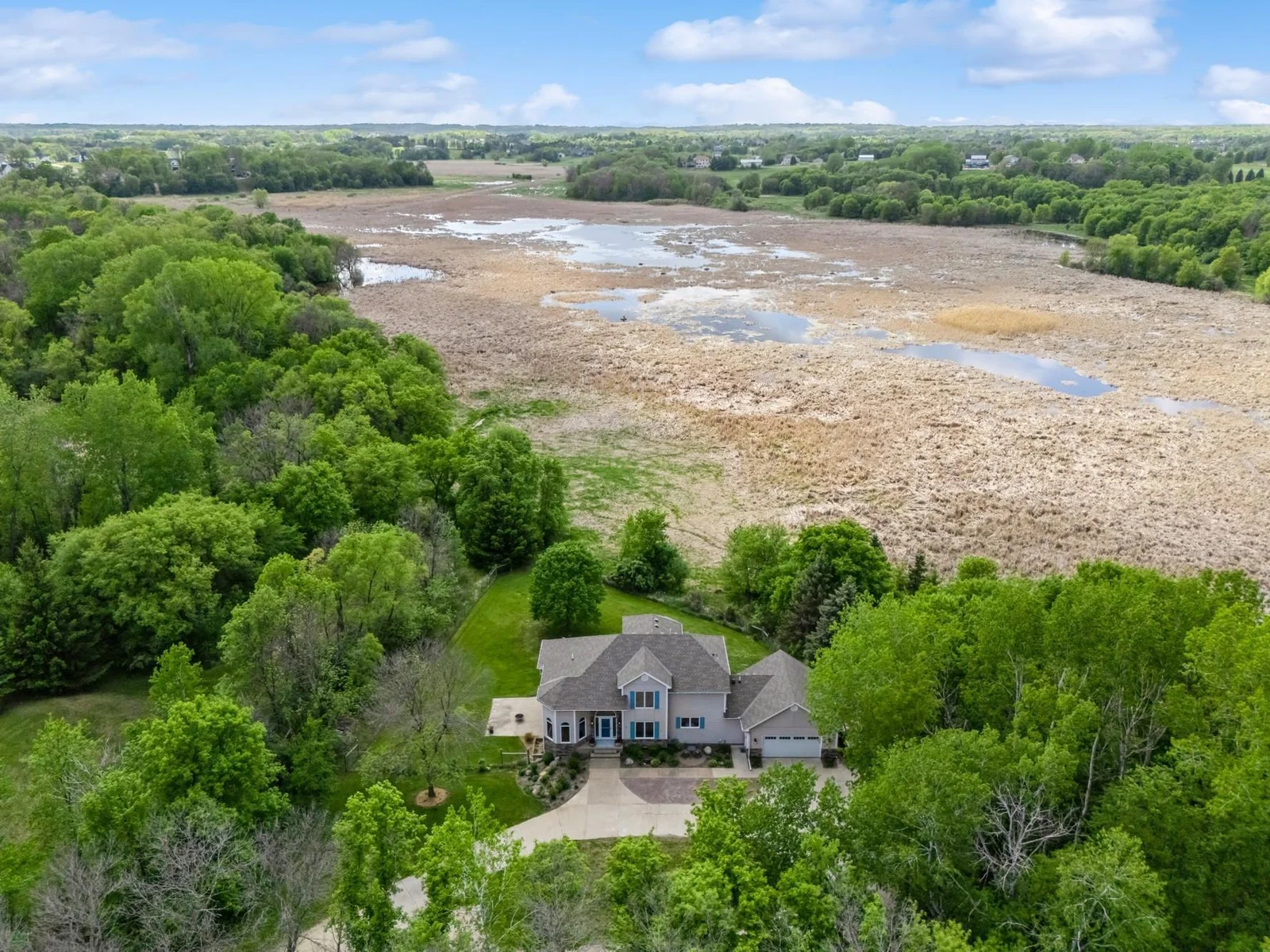 Peaceful setting on 6.5 acres with sweeping views of wildlife filled wetlands and wooded privacy.