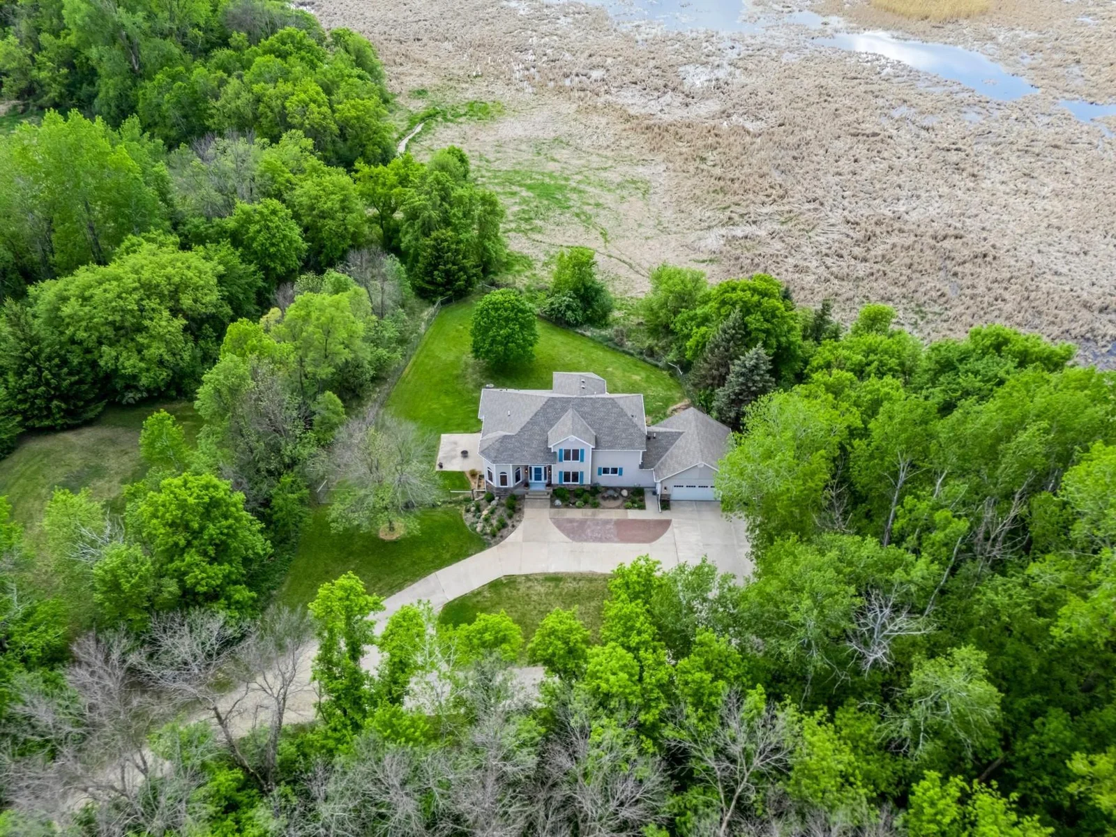 Nestled into 6.5 private acres and backs to the peaceful wetlands of Credit River