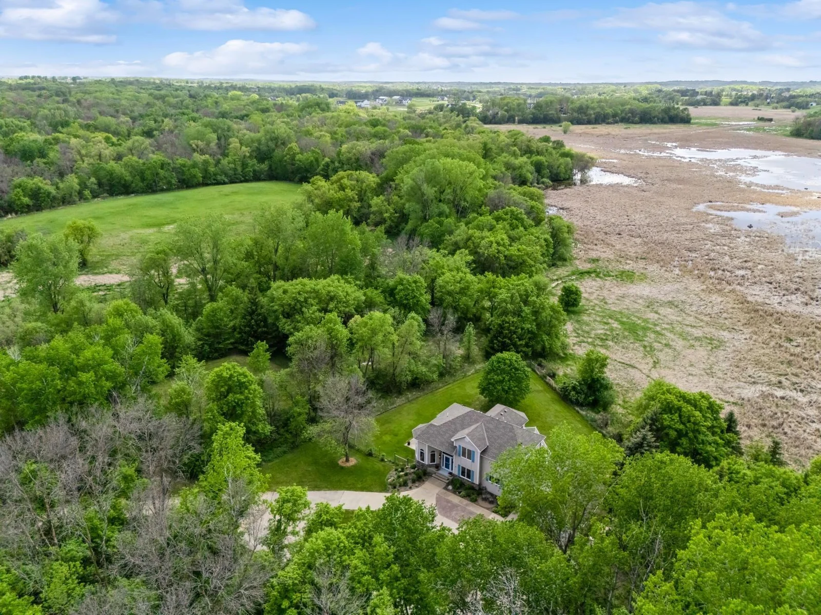 Peaceful setting on 6.5 acres with sweeping views of wildlife filled wetlands and wooded privacy.