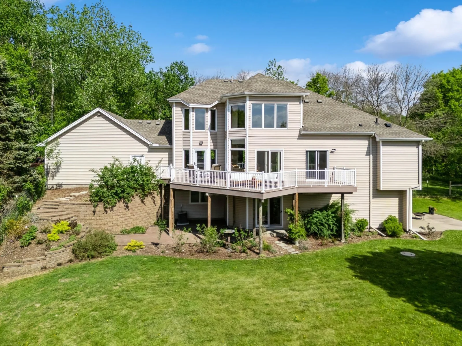 Beautiful and very private backyard to be enjoyed from the maintenance free deck or either of 2 patios.