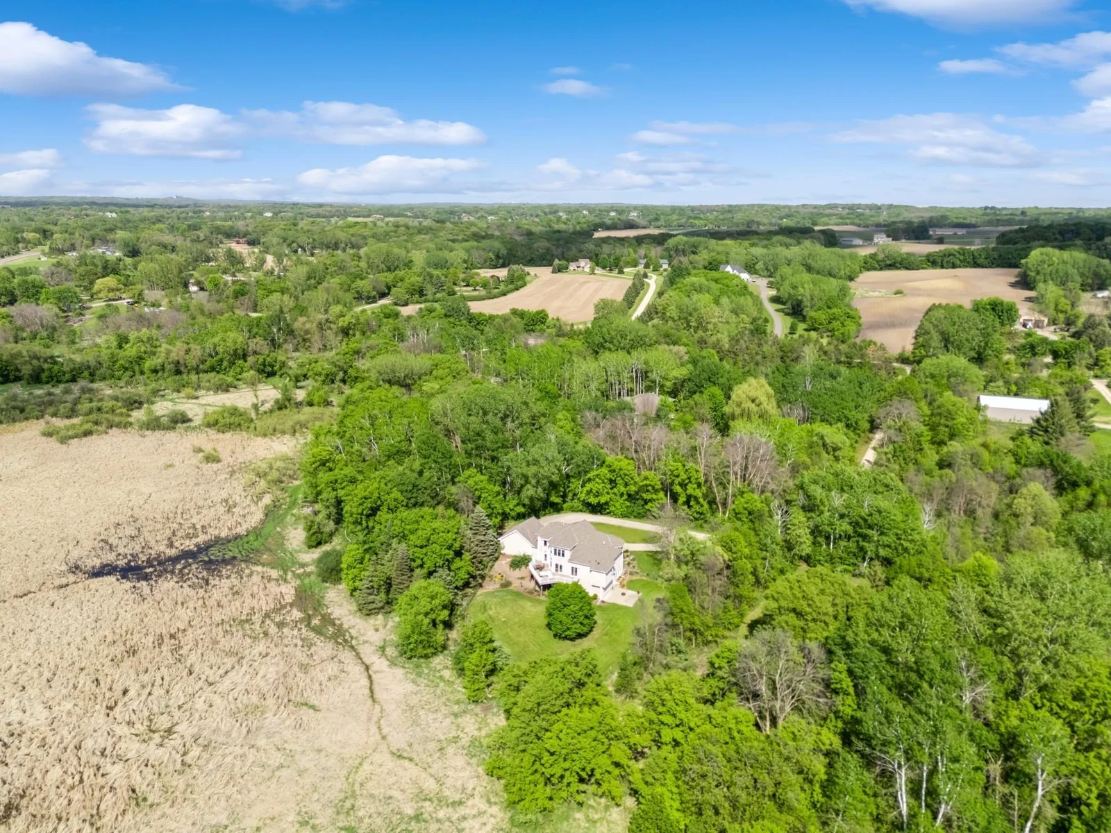 Peaceful setting on 6.5 acres with sweeping views of wildlife filled wetlands and wooded privacy.