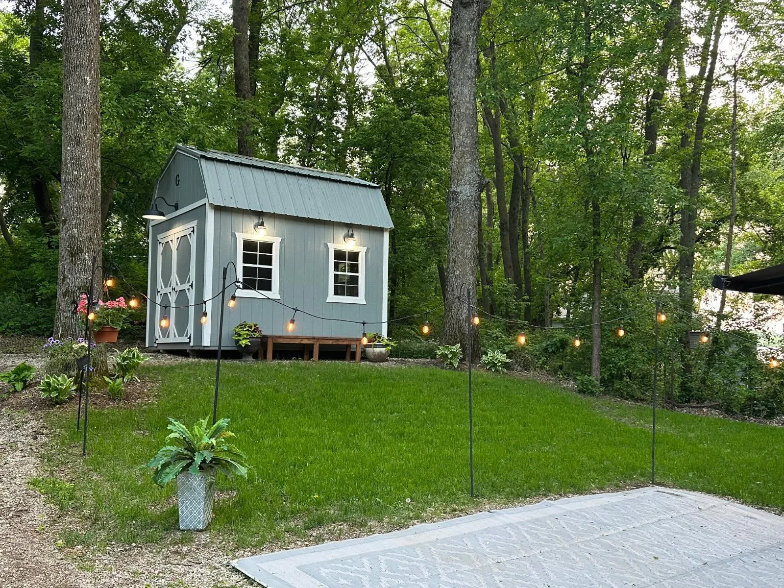 Unit 63 has pretty trees, green grass, a great parking pad for a heavy RV and a nice level pad for a shed.
