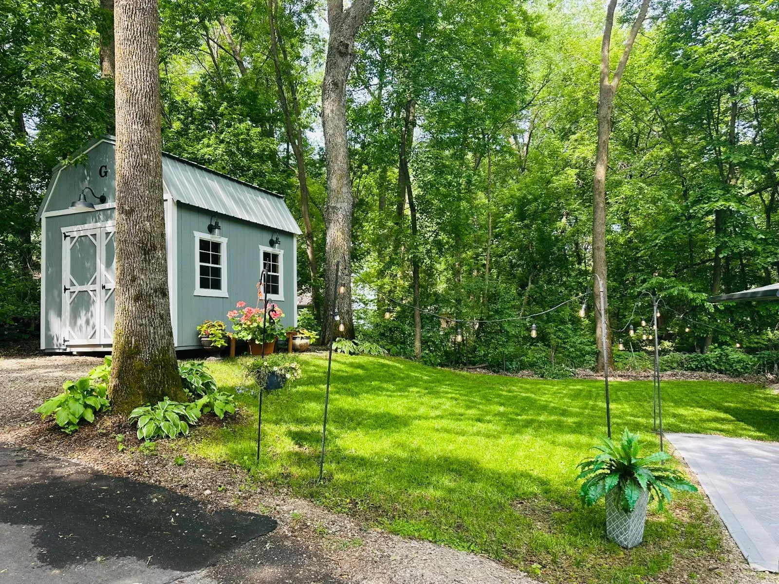 Unit 63 has pretty trees, green grass, a great parking pad for a heavy RV and a nice level pad for a shed.