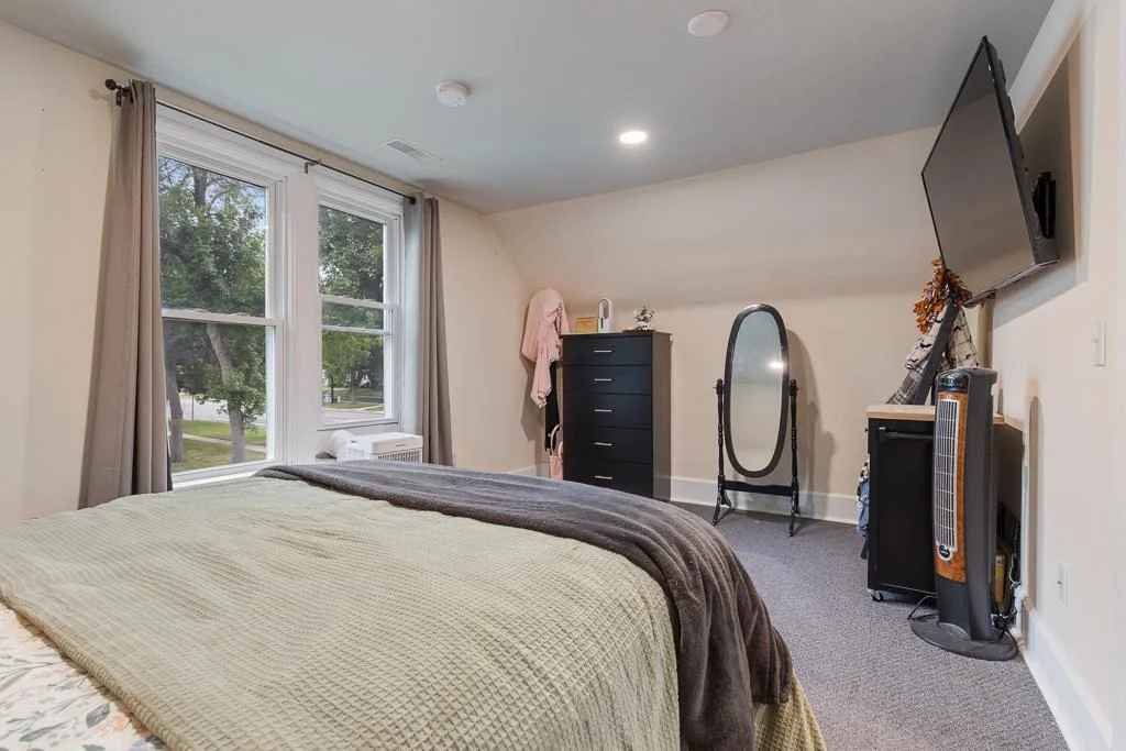 Thoughtfully refreshed with new paint and modern recessed lighting, this bedroom offers a bright and stylish space—perfect for guests, kids, or a creative setup.