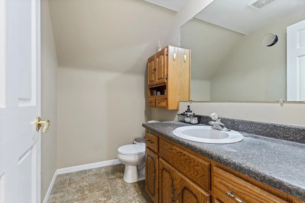 Located just steps from the bedrooms, the upstairs half bath adds everyday convenience with easy access and a clean, functional layout.