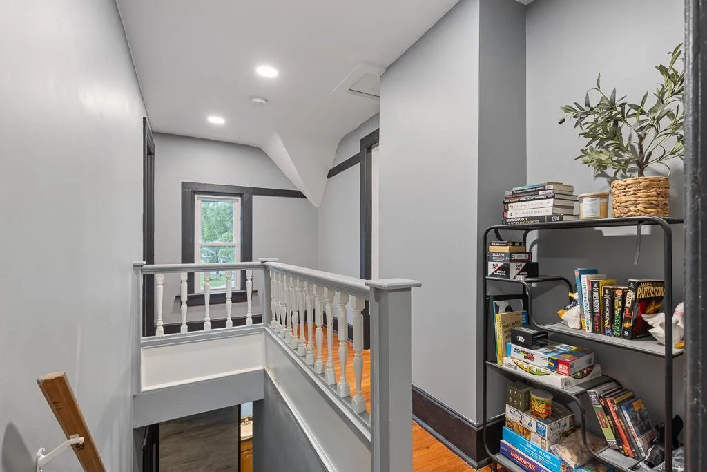 The upstairs hallway features beautiful wood floors that add warmth and character while connecting the upper-level bedrooms and bath.