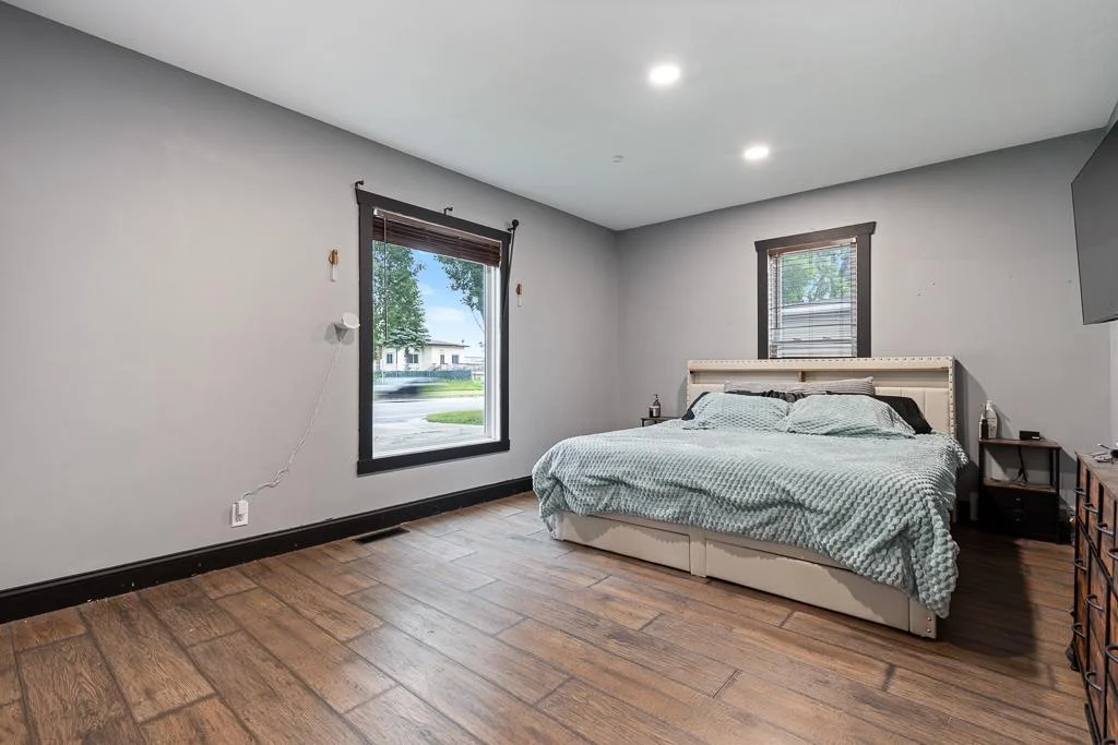 Bright and airy, this generous primary bedroom is filled with natural light, creating a peaceful and welcoming retreat.