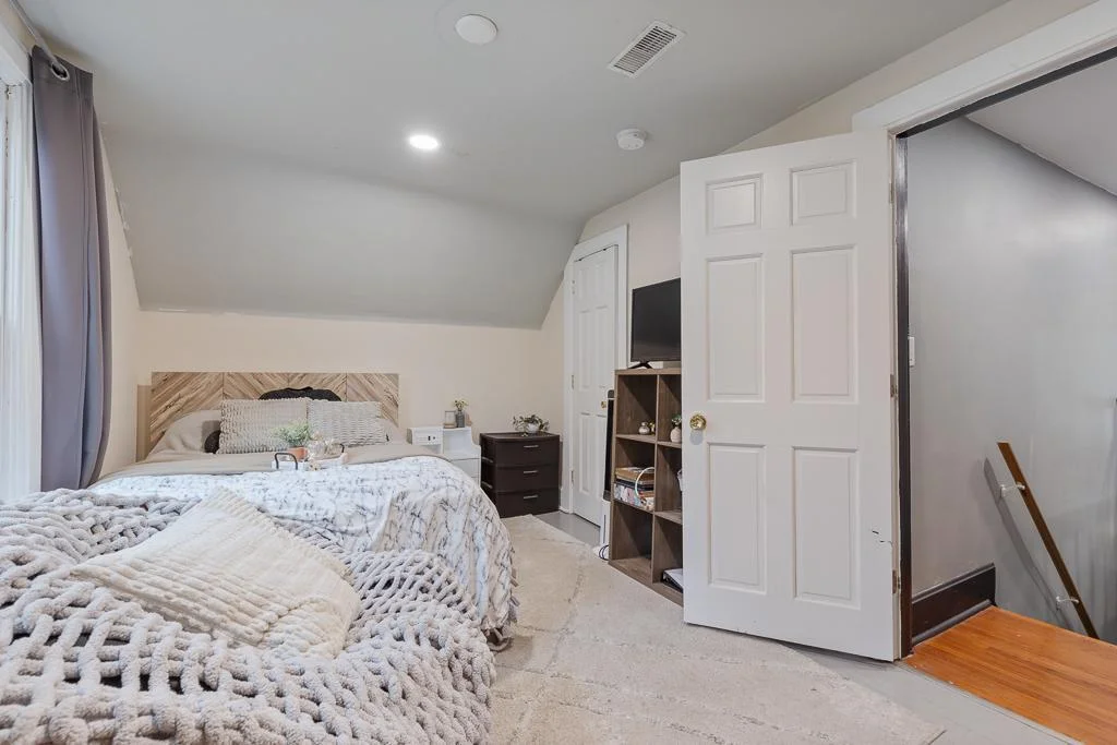 Showcasing the roomy layout and clean finishes, this shot highlights the fresh paint and recessed lighting that make the space feel open and inviting.