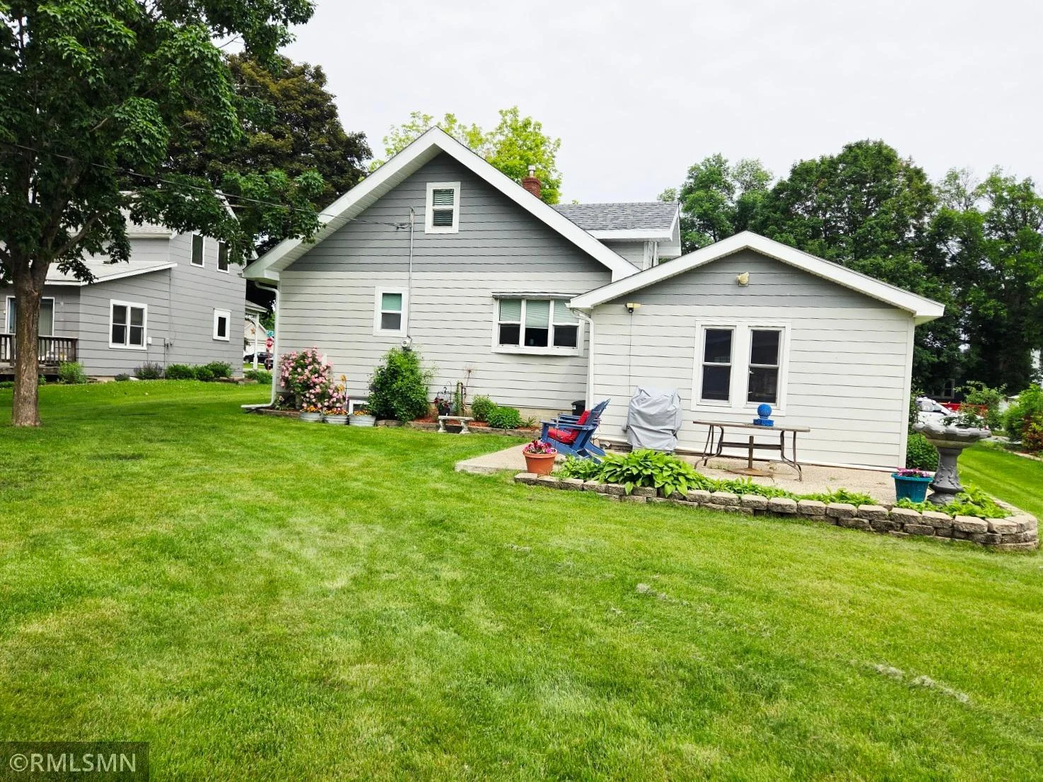 Backyard beauty with blooming flowers and room to unwind.