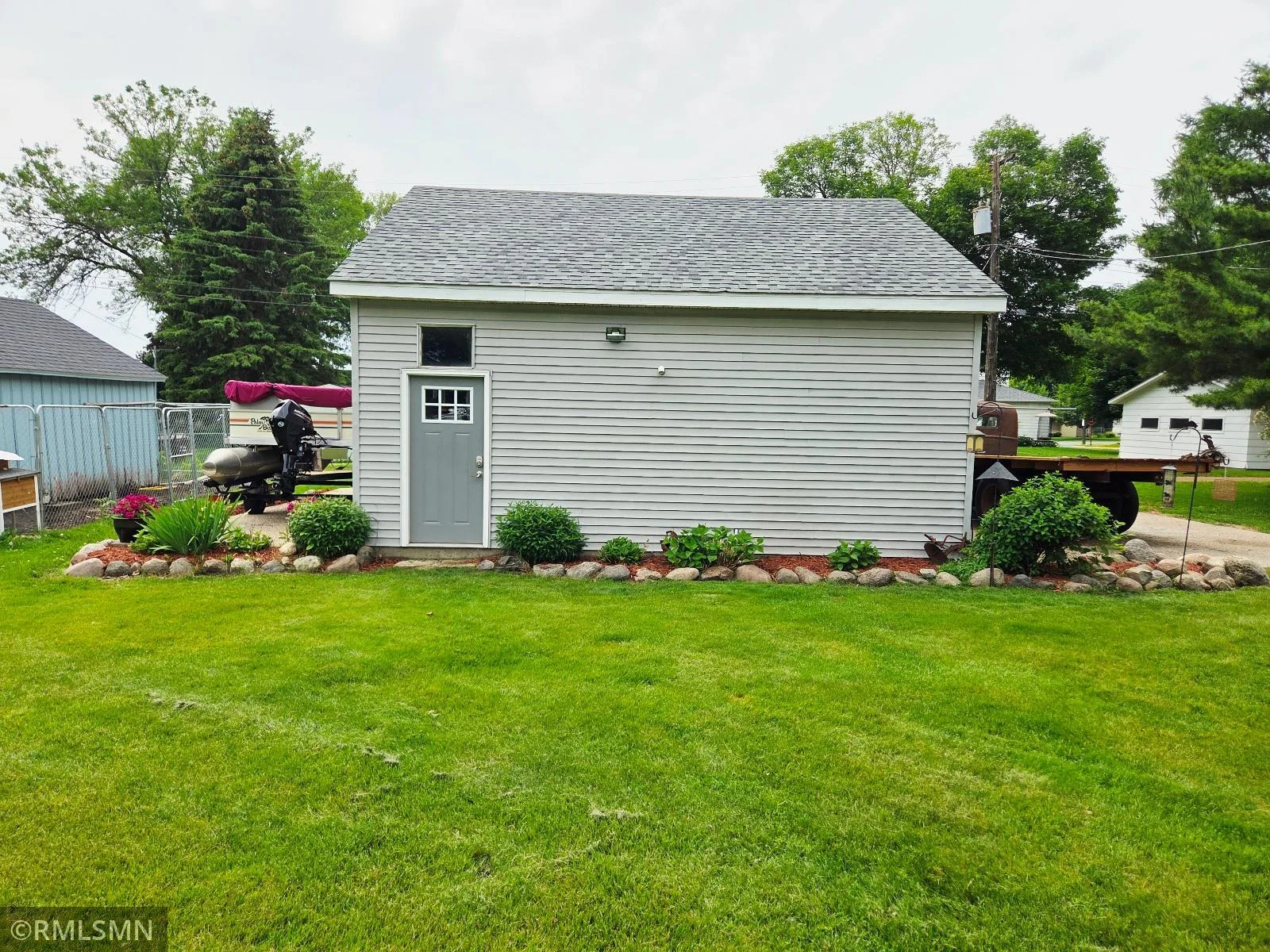 Lush backyard and extra parking spots next to the garage.