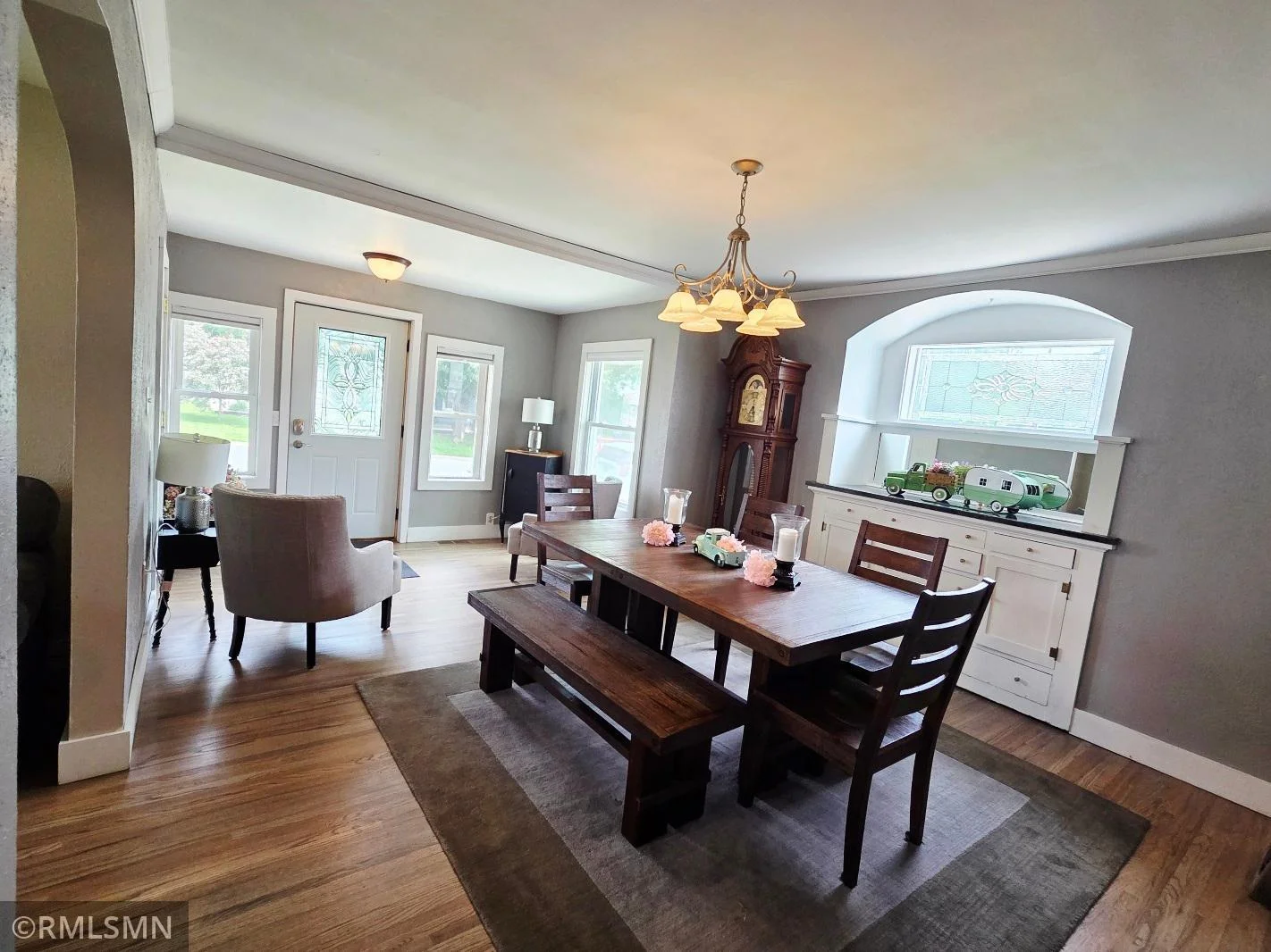 Beautifully refinished hardwood floors add warmth, while windows fill every room with natural light.