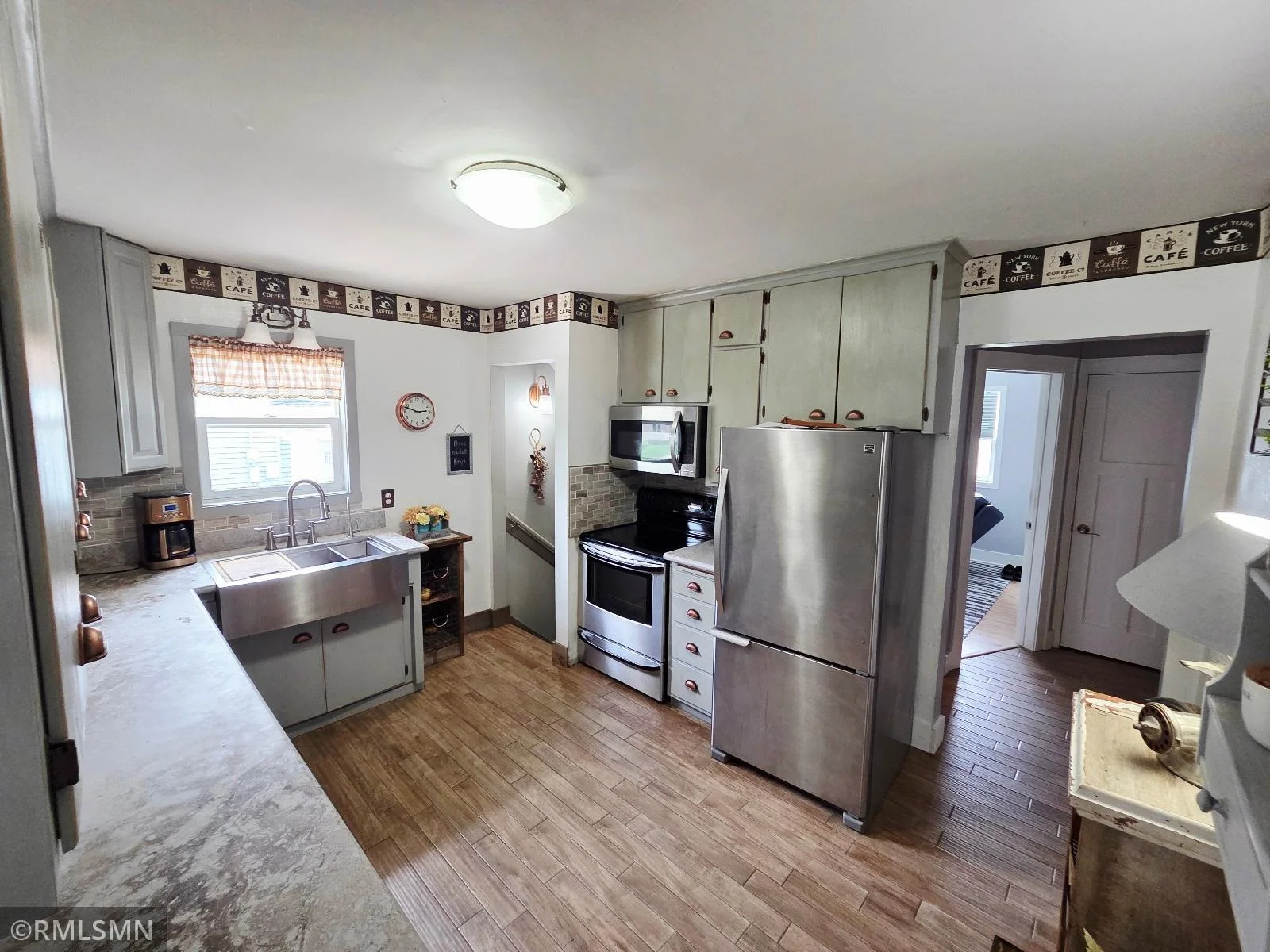 New quartz countertops and a window over the sink make for a sunlit kitchen.