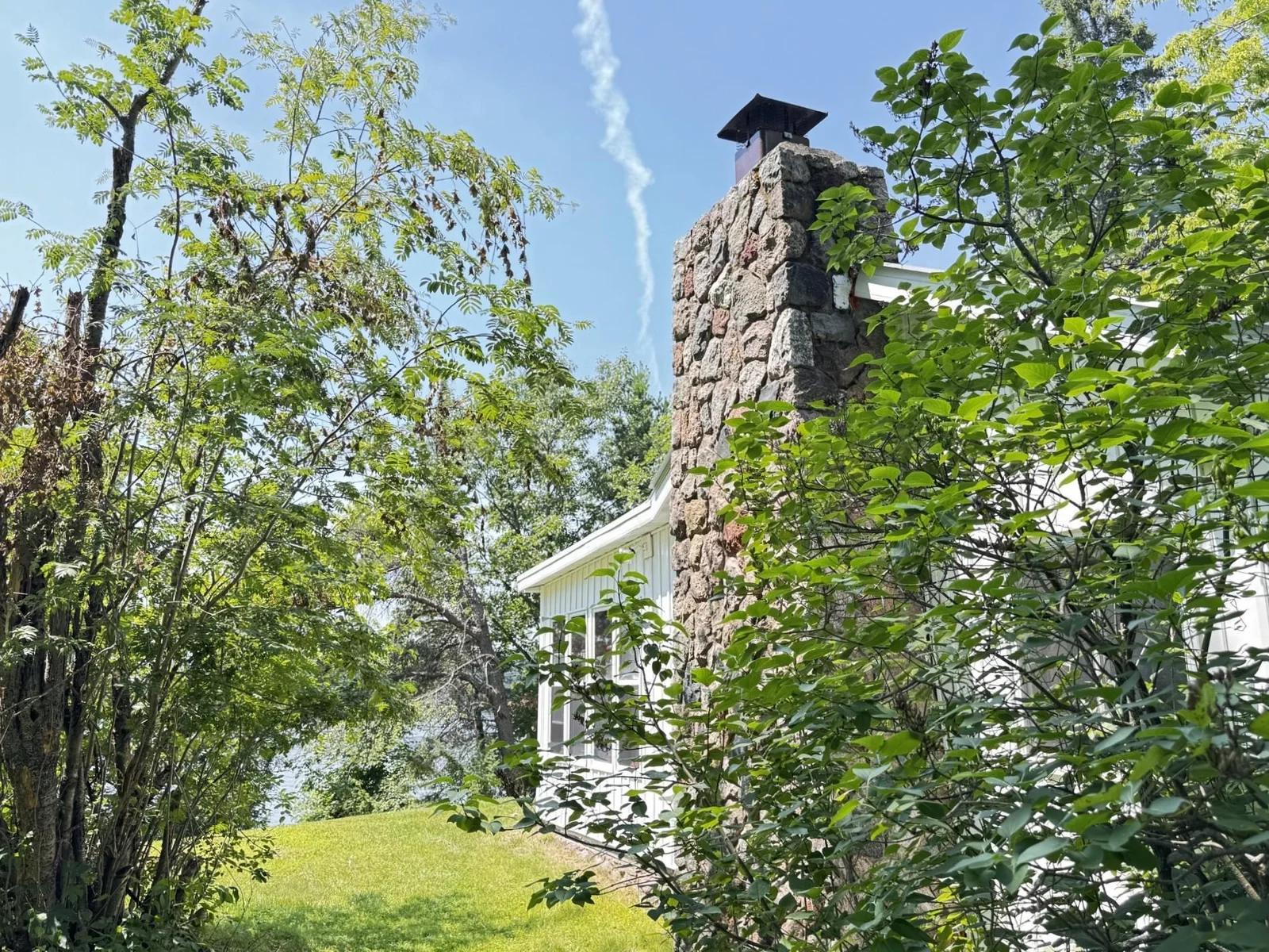 White cabin 50' from shoreline