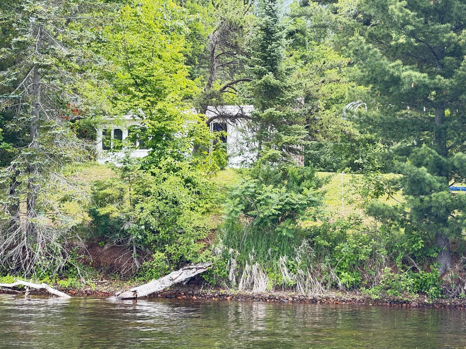 White cabin view from lake