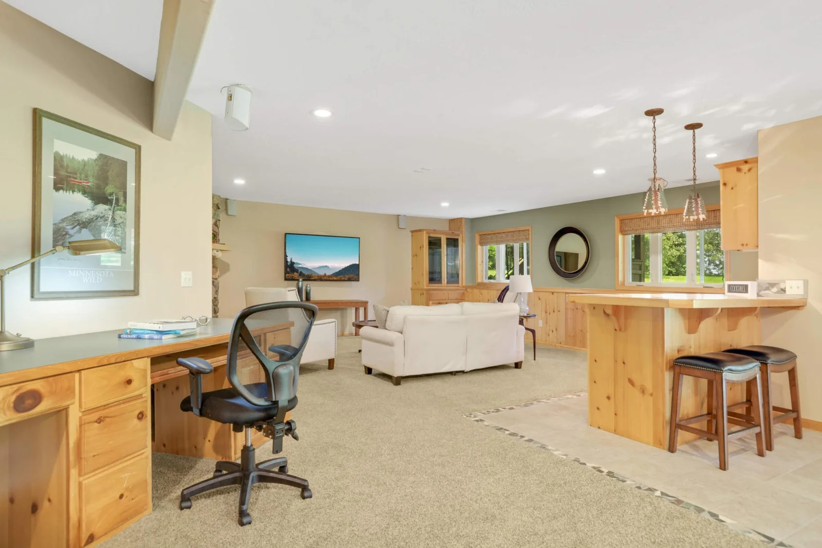 The large, wide-open family room is designed for living and entertaining without limits—featuring a walk-up bar and built-in workstation, it’s the perfect blend of relaxation, productivity, and fun.