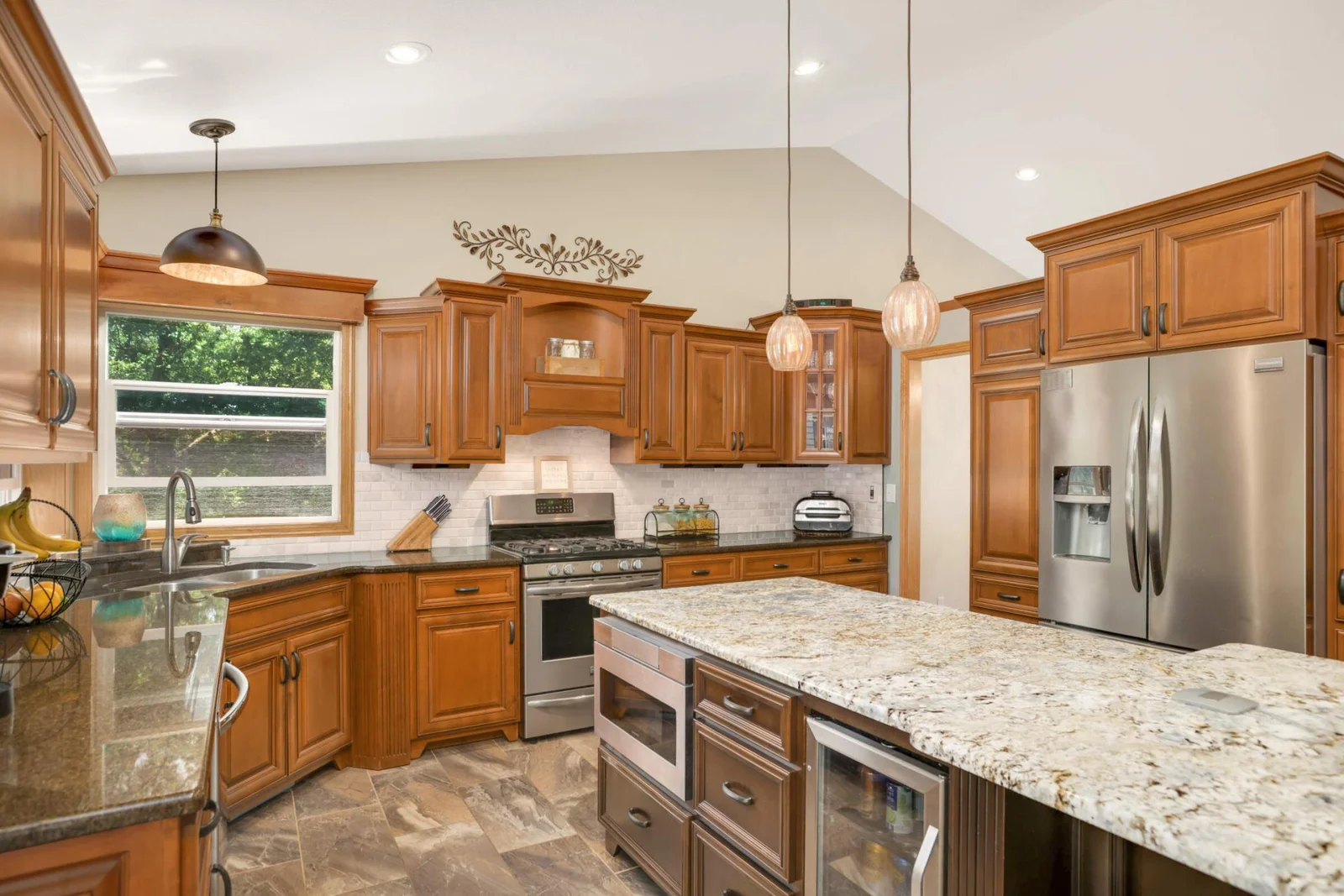 The kitchen is both stylish and smart, featuring heated tile floors for cozy comfort underfoot and convenient under-cabinet plug-ins that keep your counters clutter-free