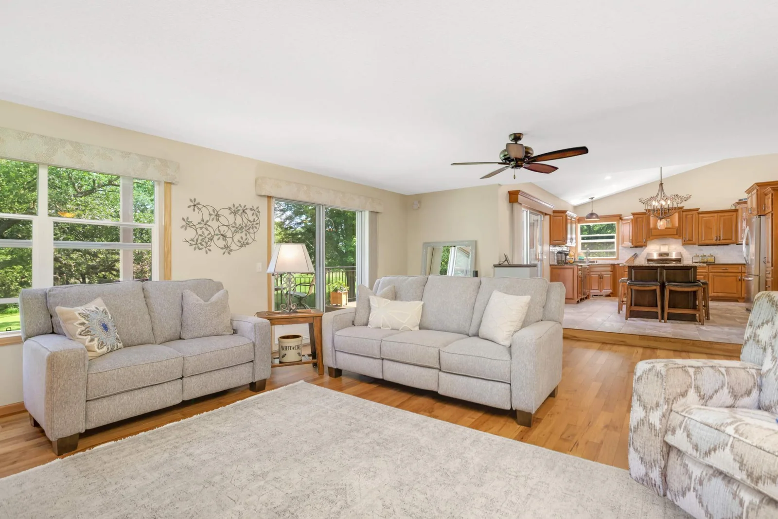 The living room wraps you in cozy comfort all winter long with its inviting fireplace and rich natural finishes, while oversized windows flood the space with sunshine all year