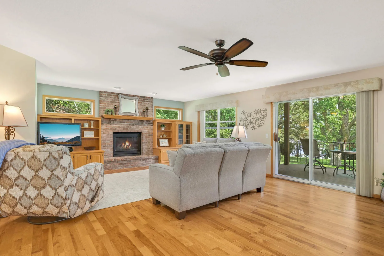 One of two screened entrances to the expansive deck offers a seamless indoor-outdoor flow—perfect for enjoying the breeze without the bugs.